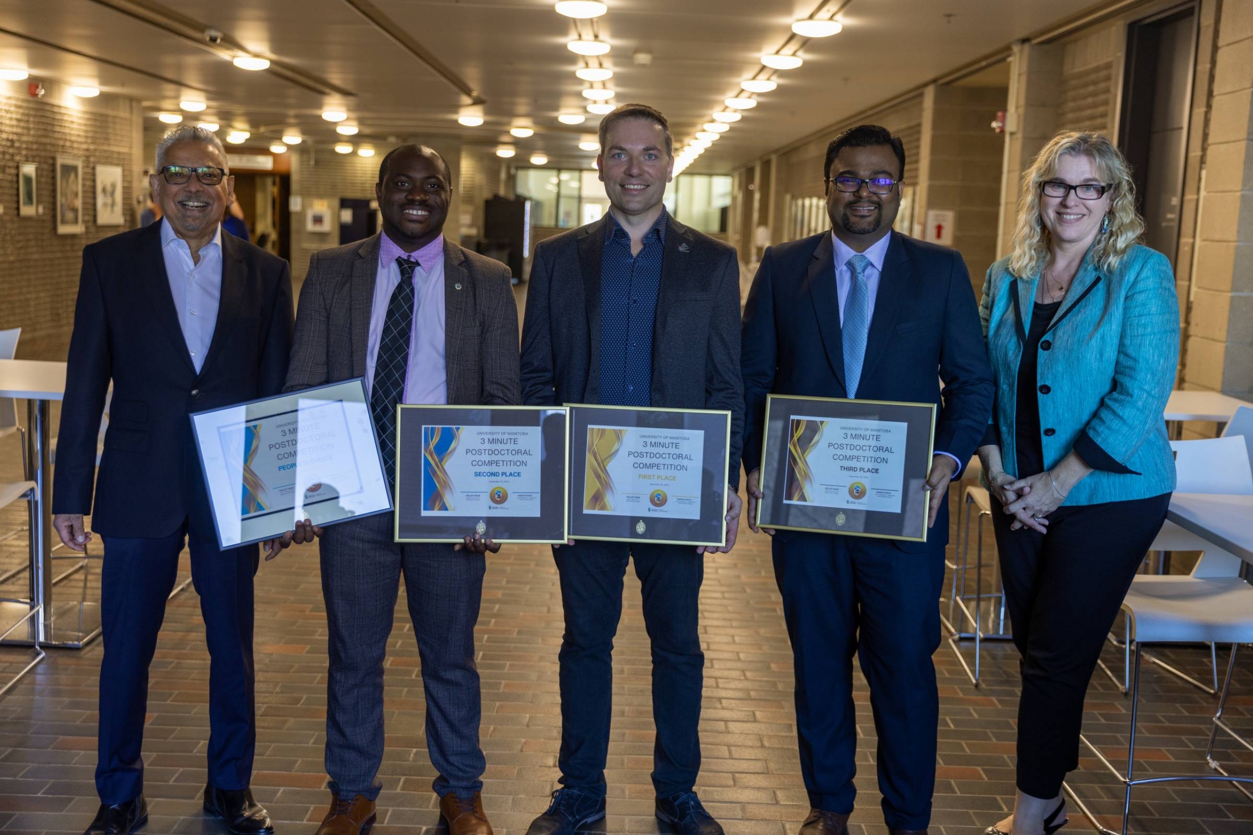 Mario Pinto and Kelley Main with winners of the 2024 Three-Minute Postdoc competition holding their certificates.