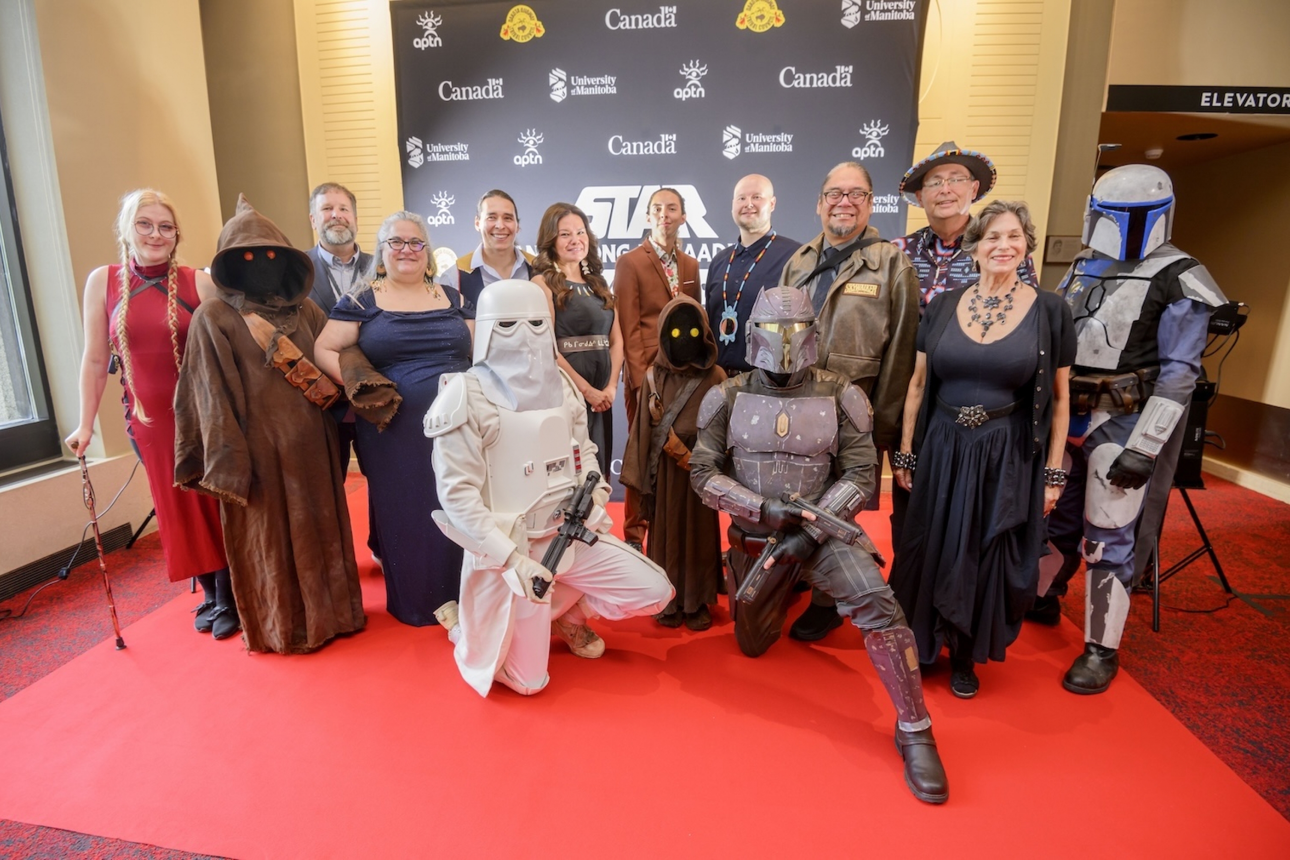 Voice cast, filmmakers and costumed characters on red carpet at “Star Wars (Anangong Miigaading), A New Hope” at the world premiere.