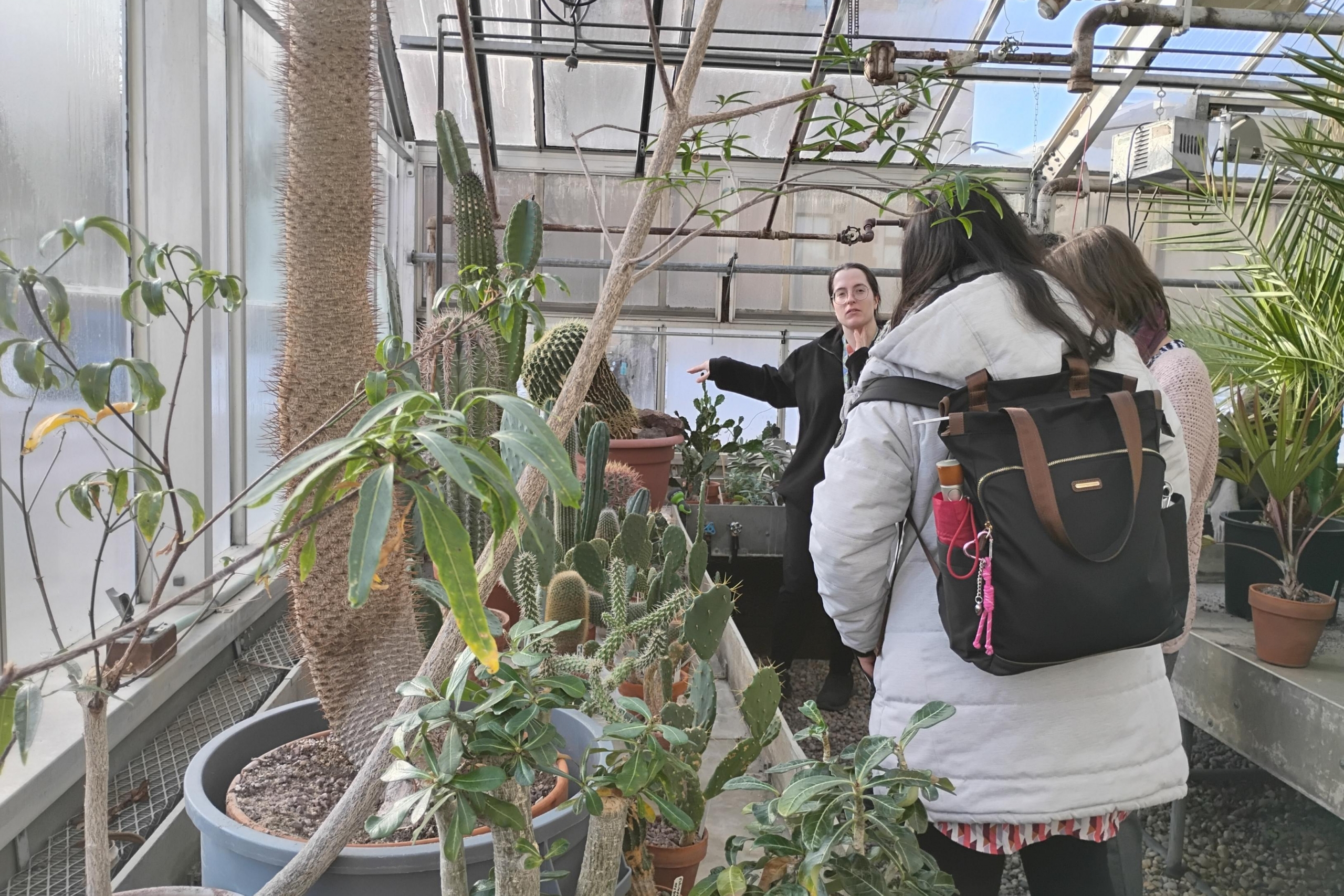 Students participate in a tour of the campus greenhouse