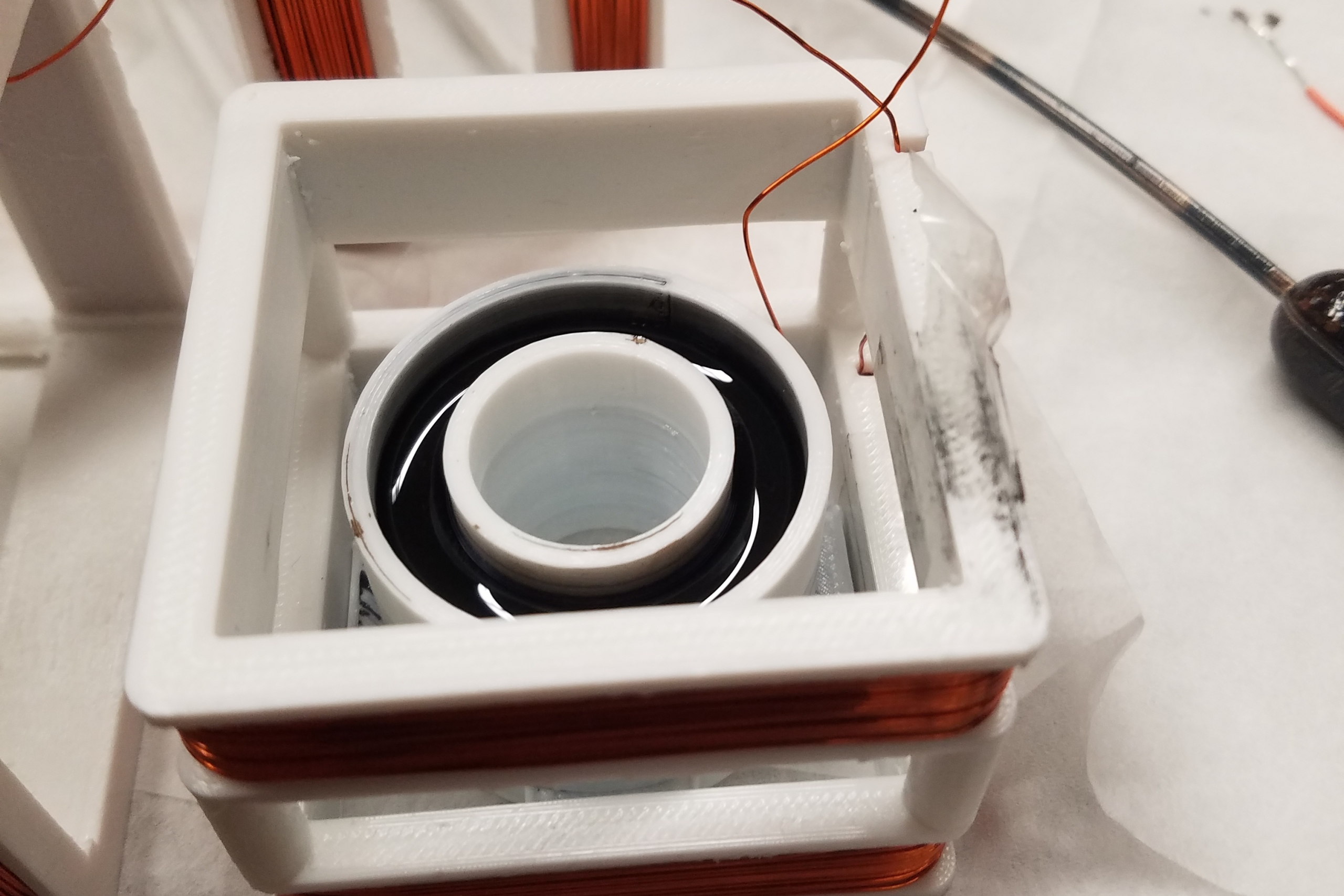 Black magnetic liquid rotating inside the reaction wheel designed by Aidan Hartry