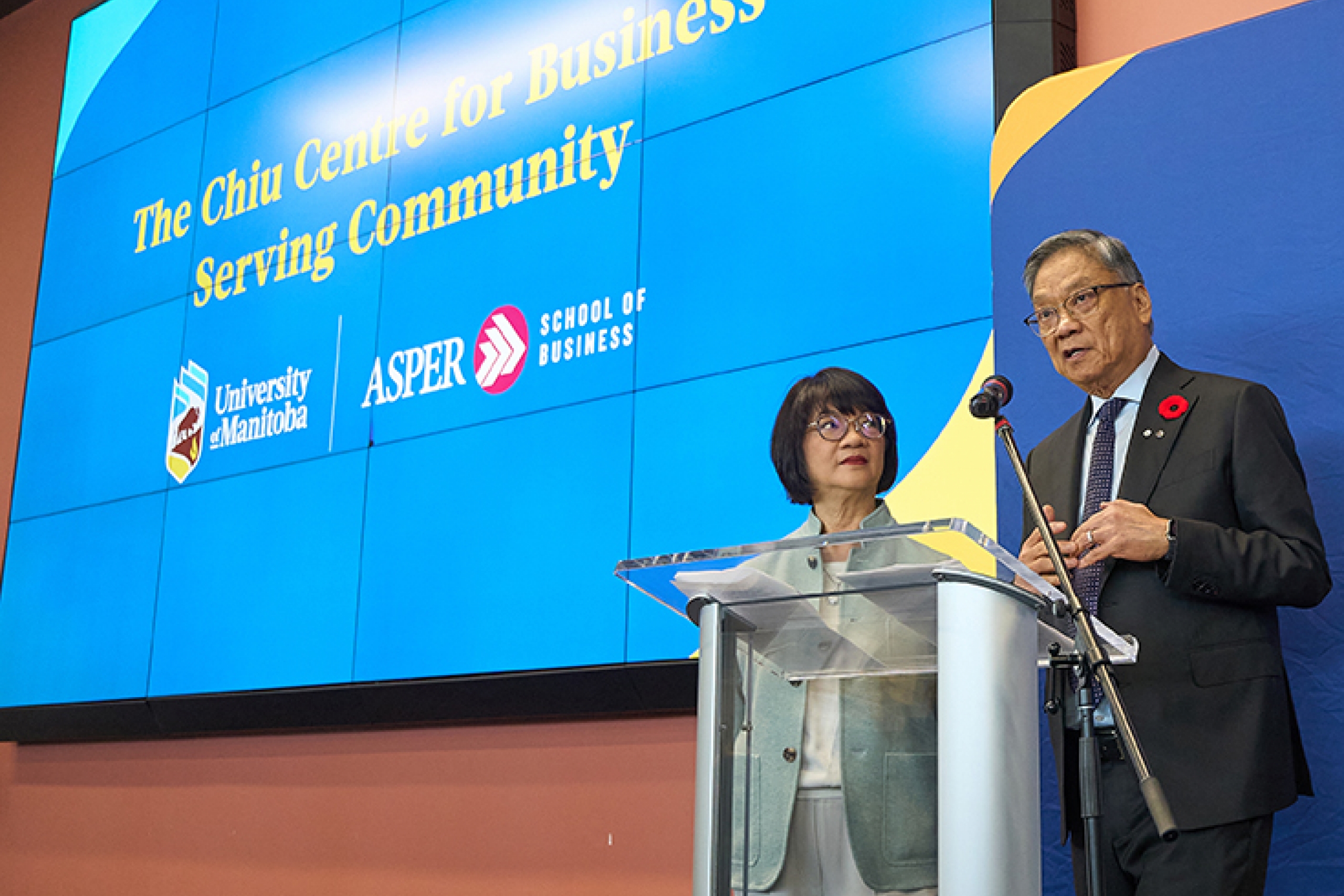 Eleanor and Wayne Chiu at podium