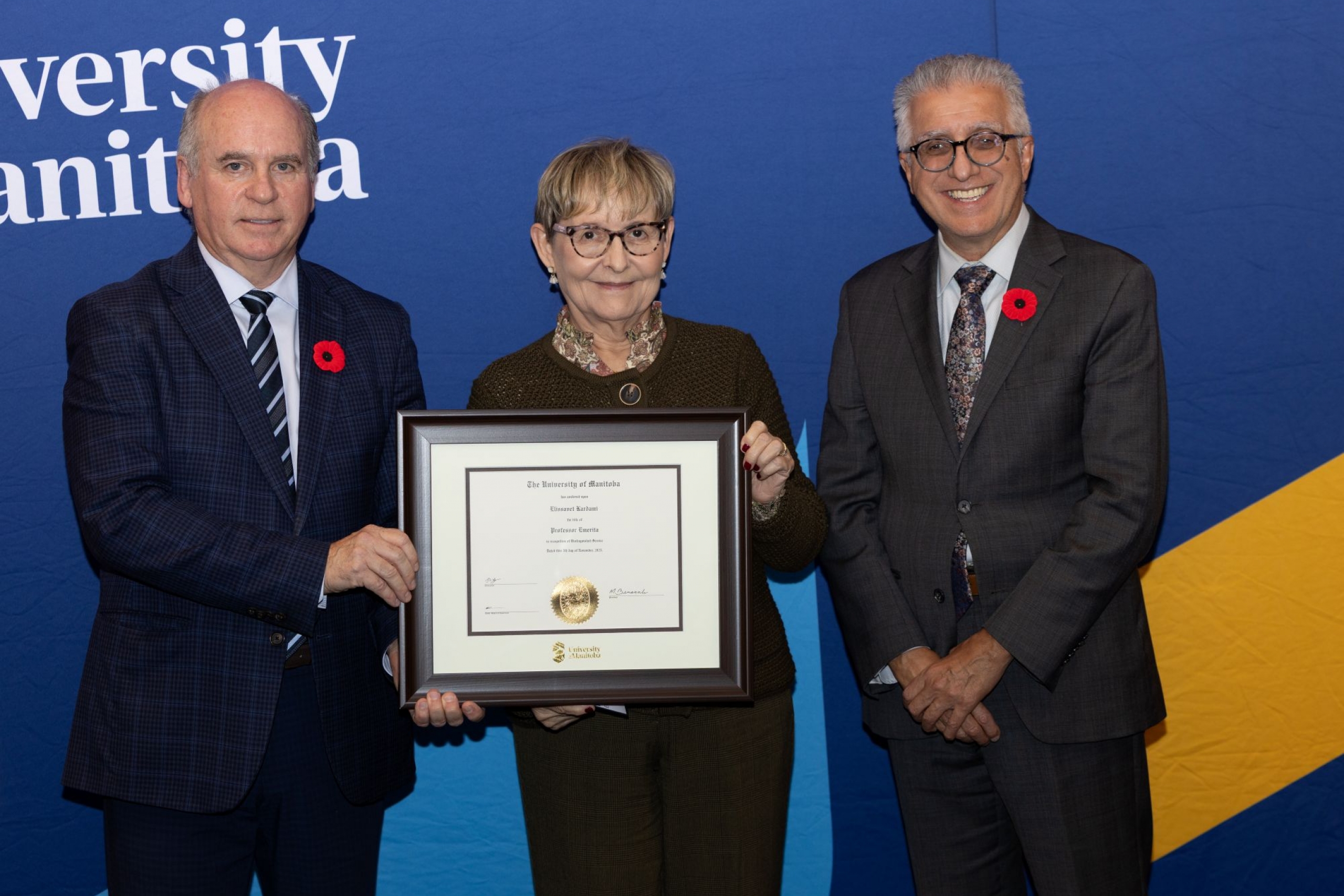 Chancellor Dave Angus and President Michael Benarroch present Elissavet Kardami with certificate.