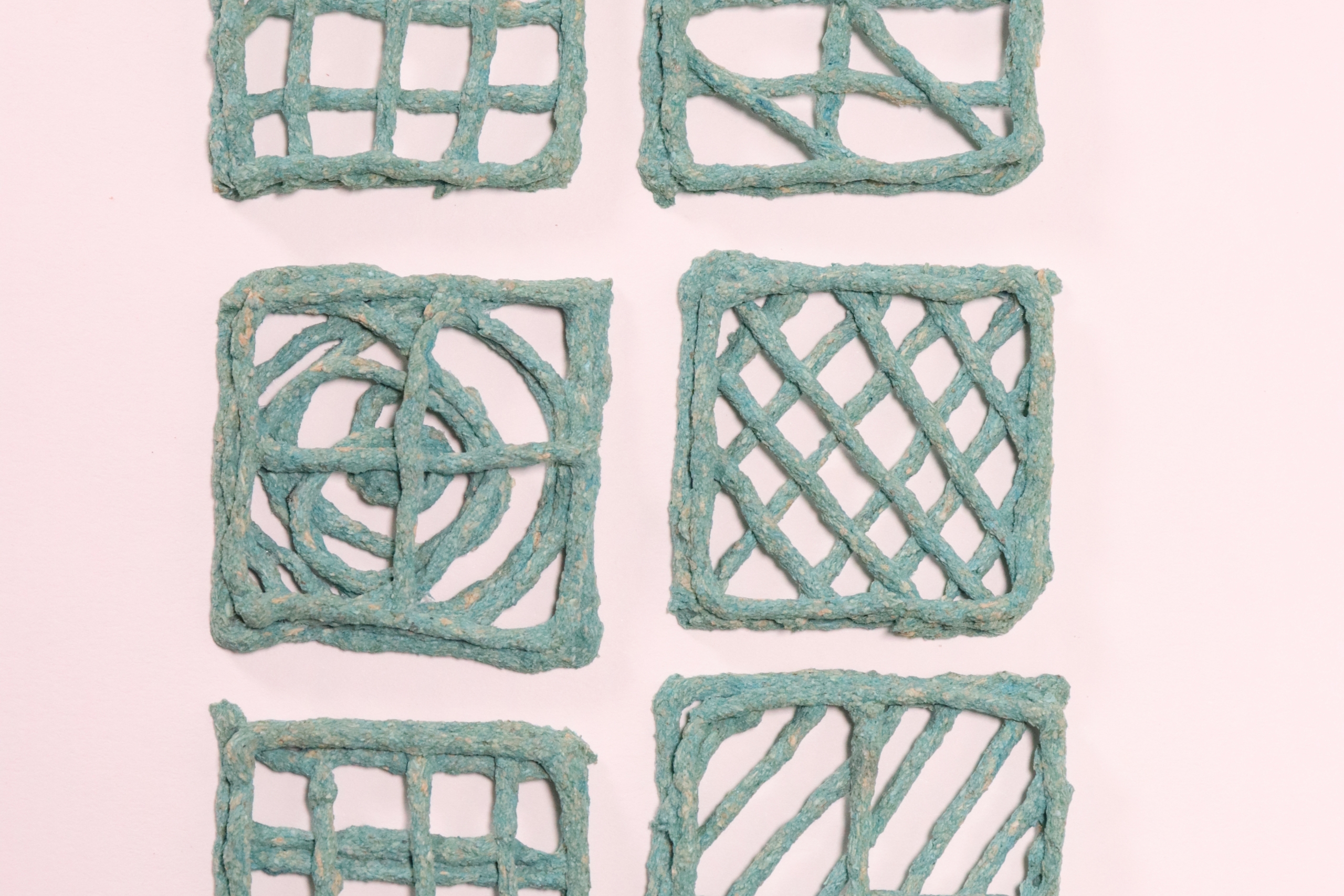 Six teal wireframe squares are arranged in two columns features unique geometric patterns.