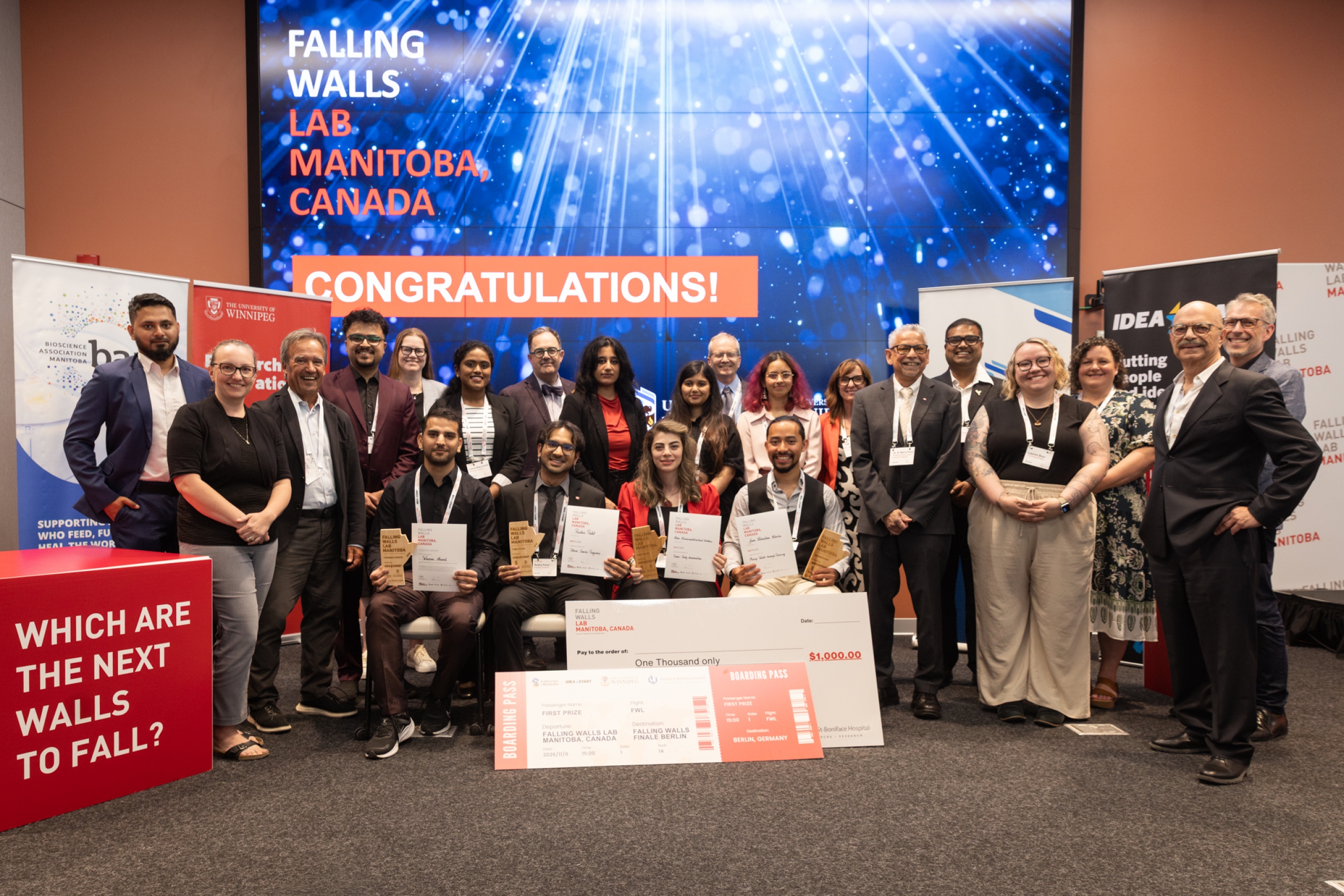 Group photo of Falling Walls Lab Manitoba 2026 finalists, winners, judges and organizers in front of a Congratulations screen.