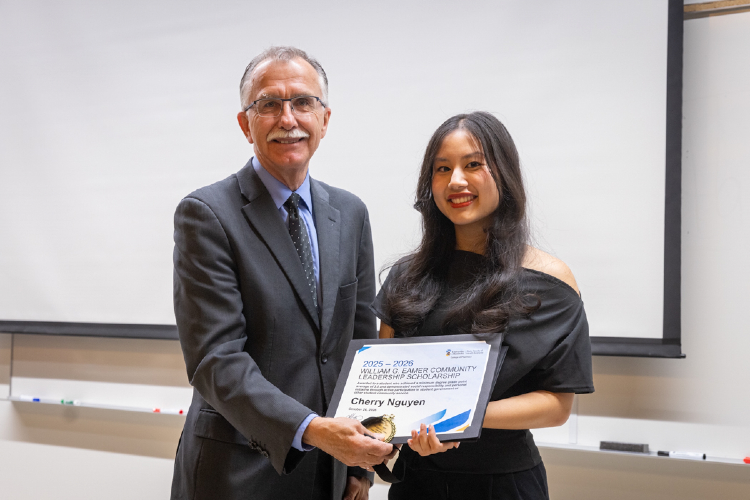 One presenter giving recipient an award.