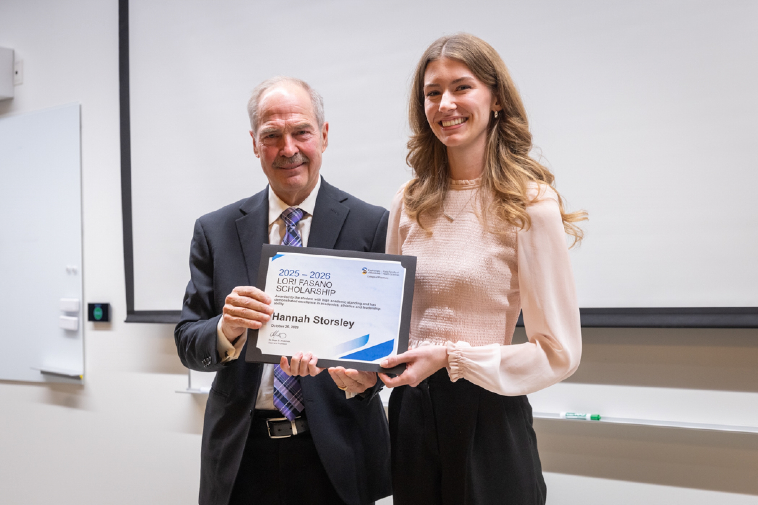 Presenter giving recipient an award.