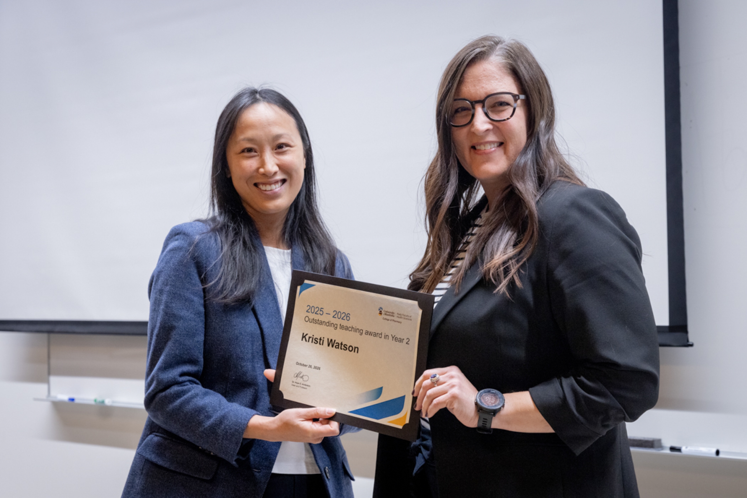 Presenter giving recipient an award.