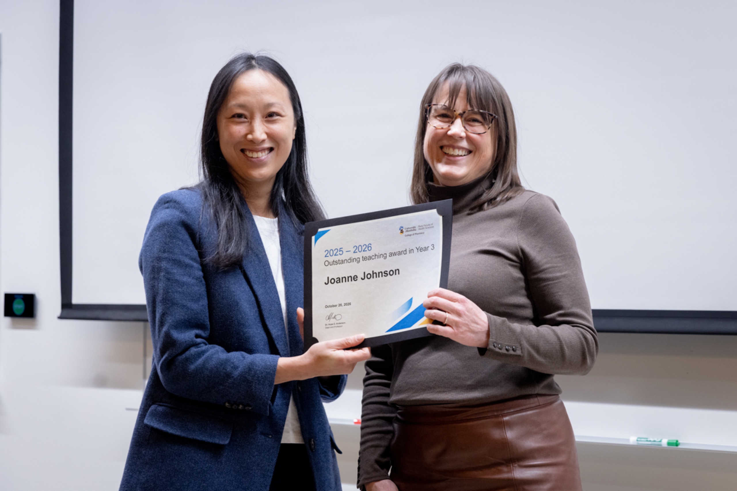 Presenter giving recipient an award.