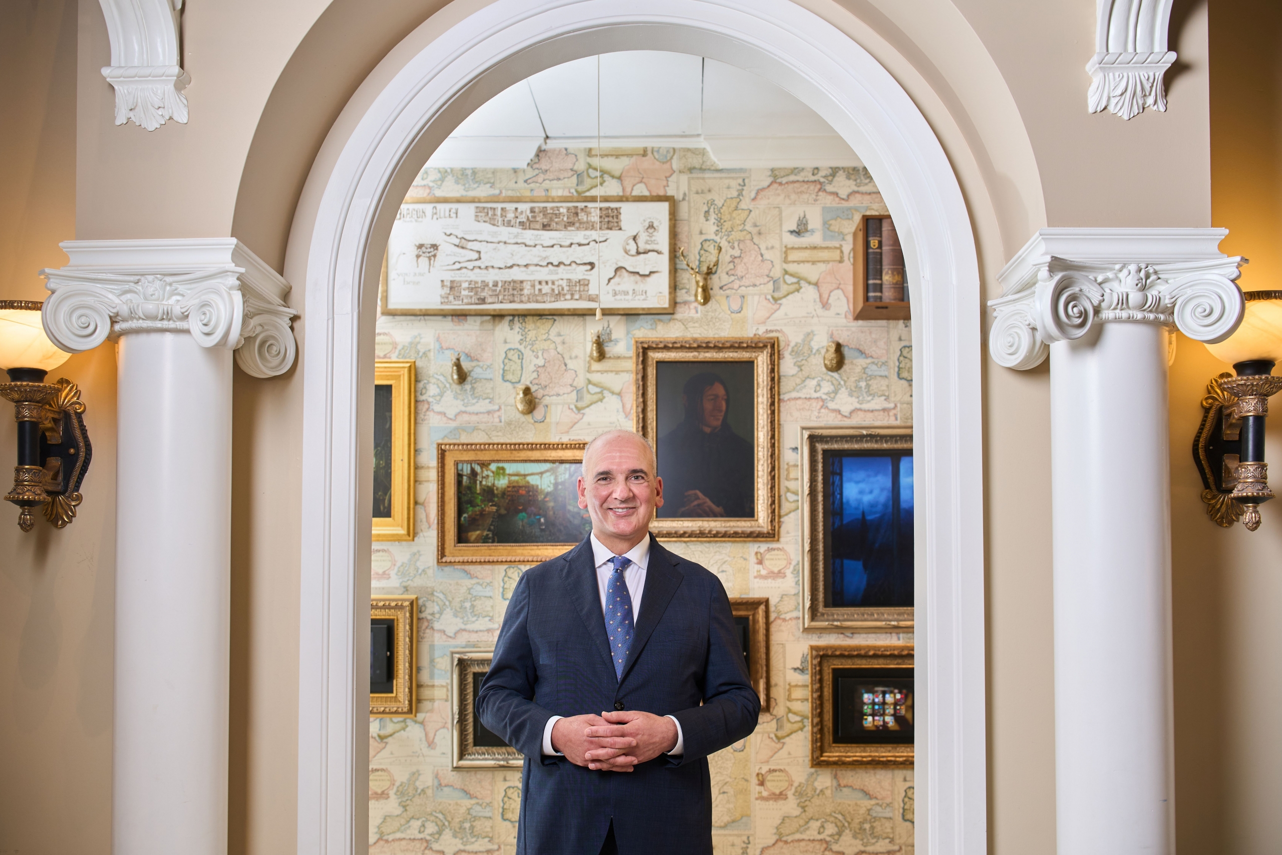 Dr. Ernest Cholakis [DMD/82] standing in his dental clinic's Harry Potter themed waiting room
