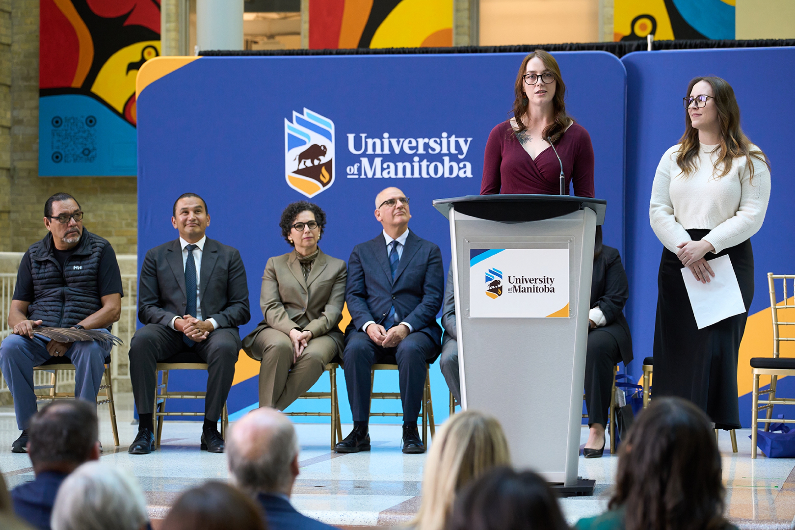 Sam Joy and Stacey Urban speaking at a podium