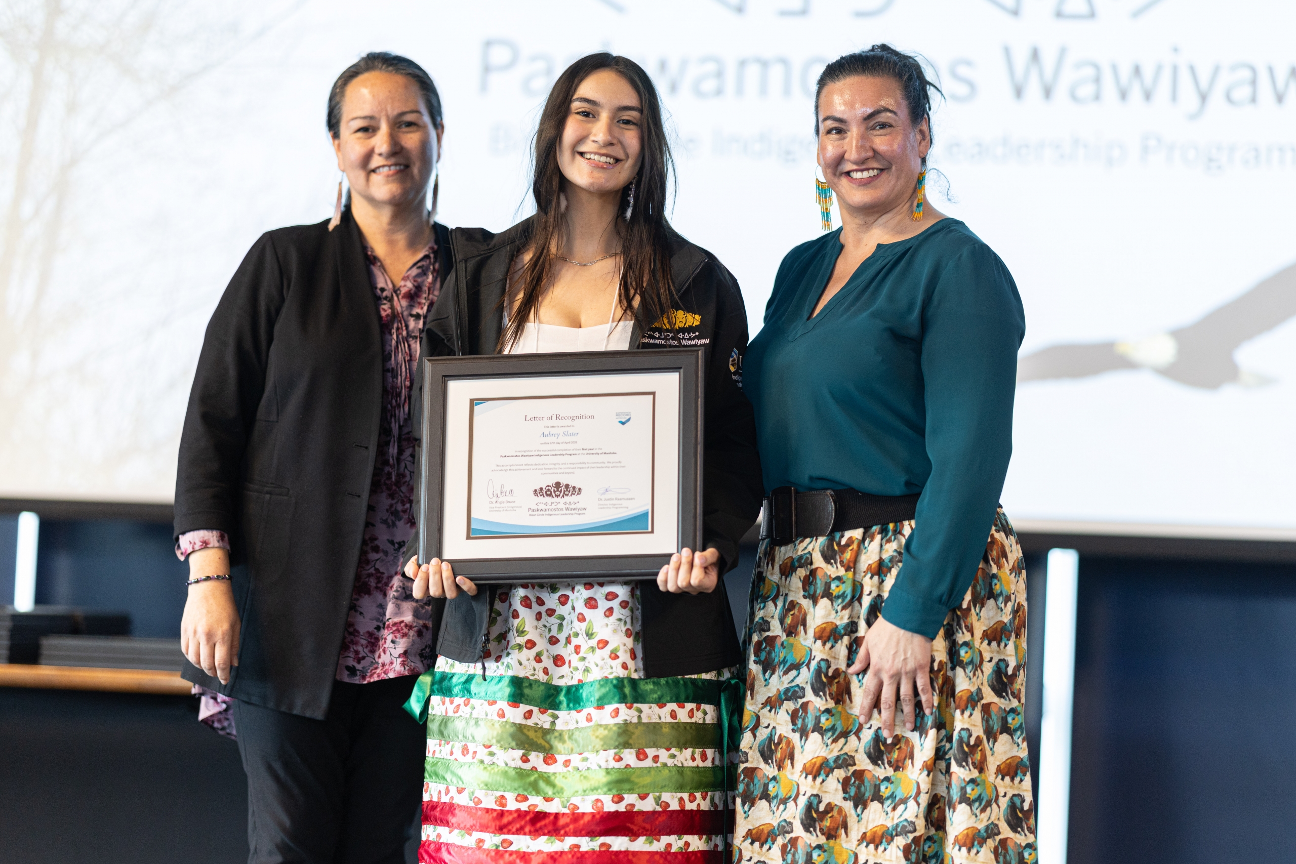 Aubrey holding certificate at Indigenous Leadership Programming event.