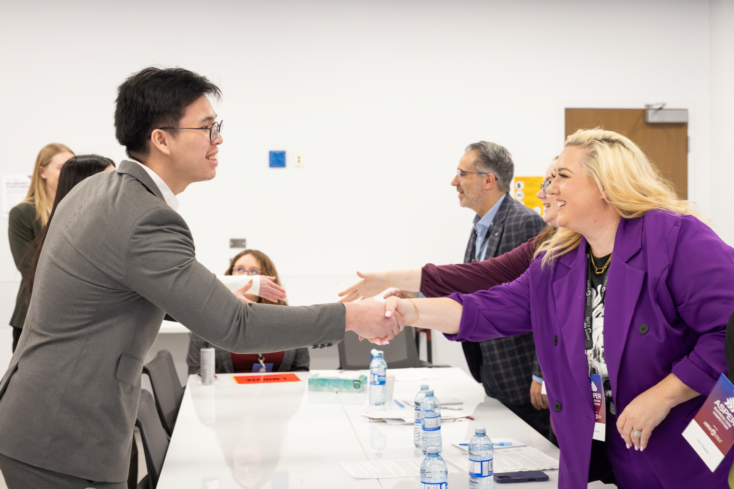 A competitor and a judge handshake