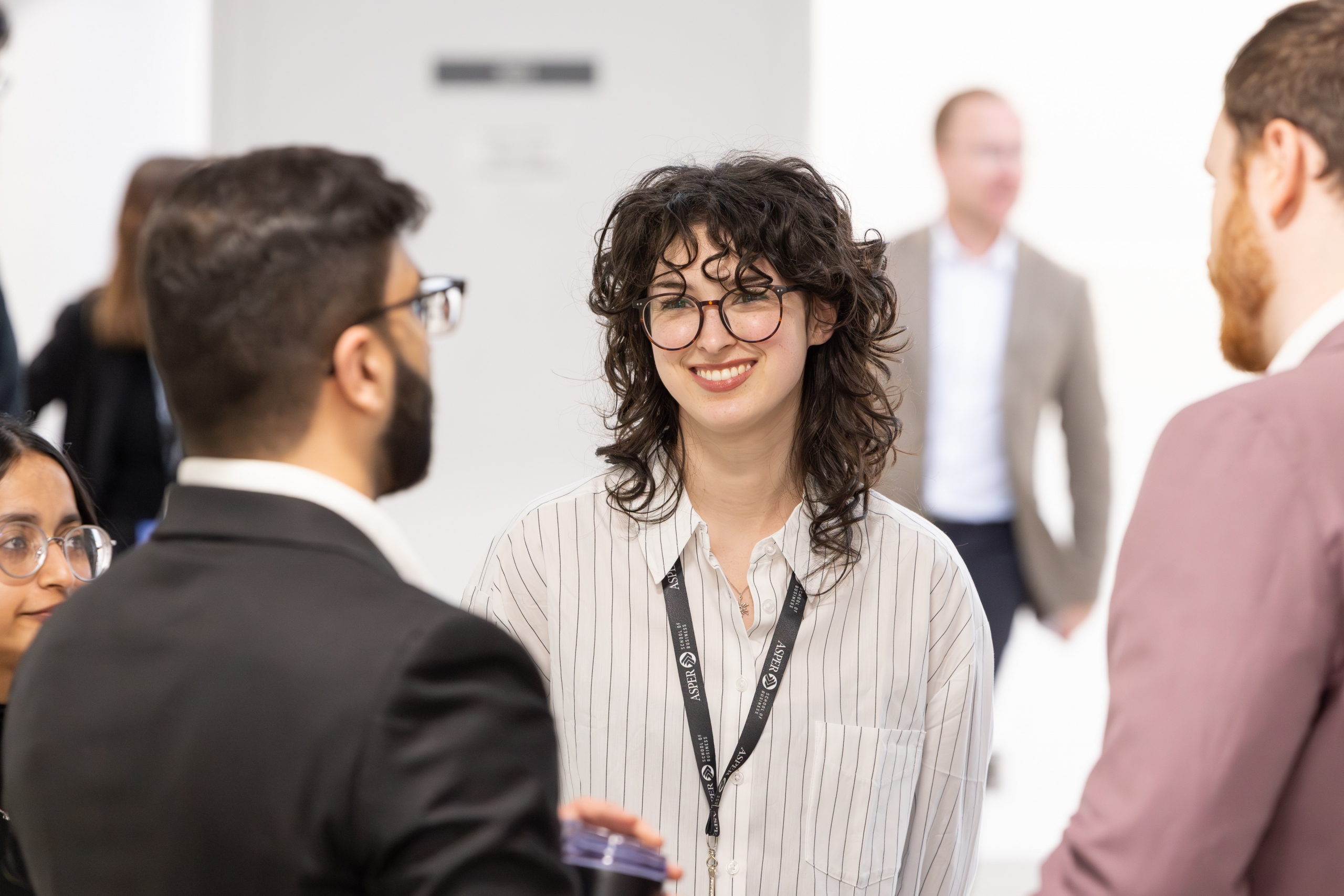 A competitor stands with her teammates smiling