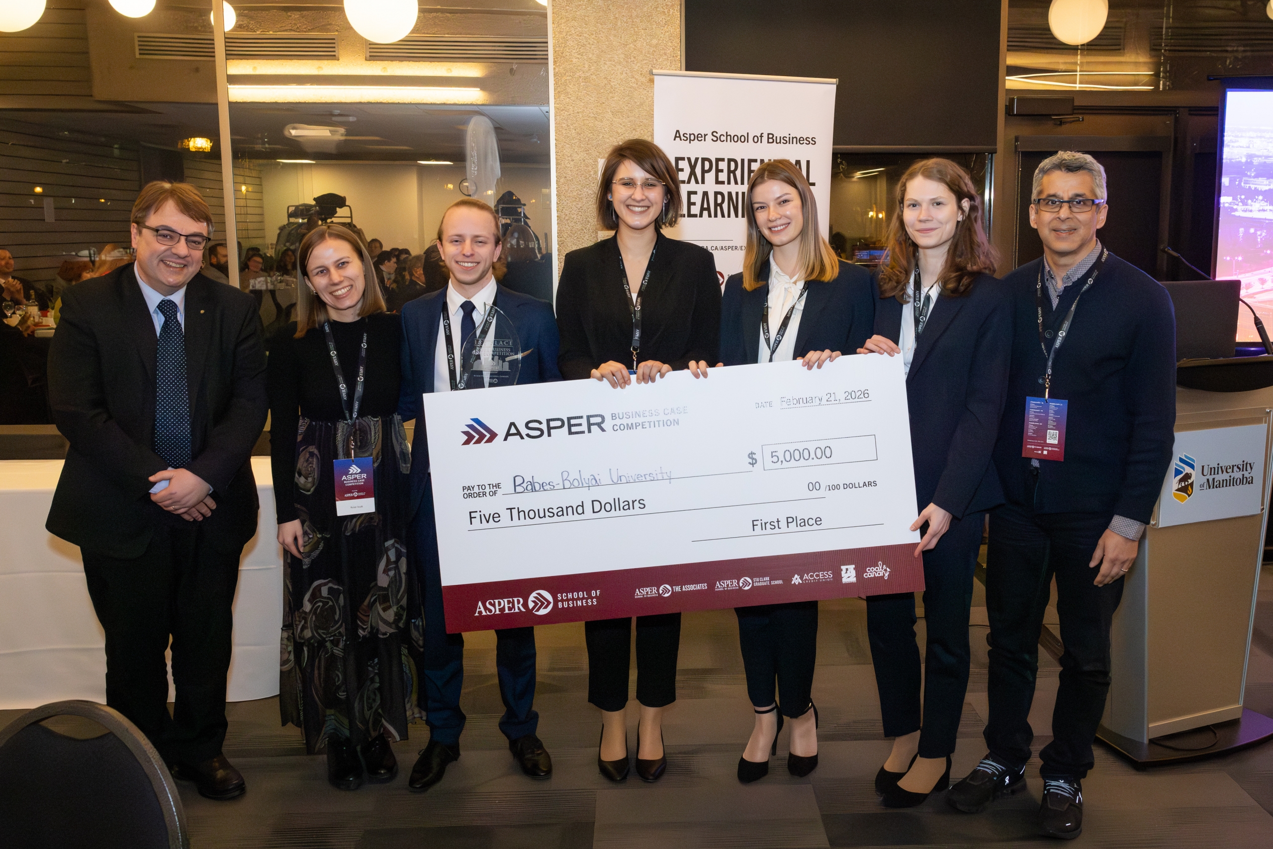 A group holding a big cheque