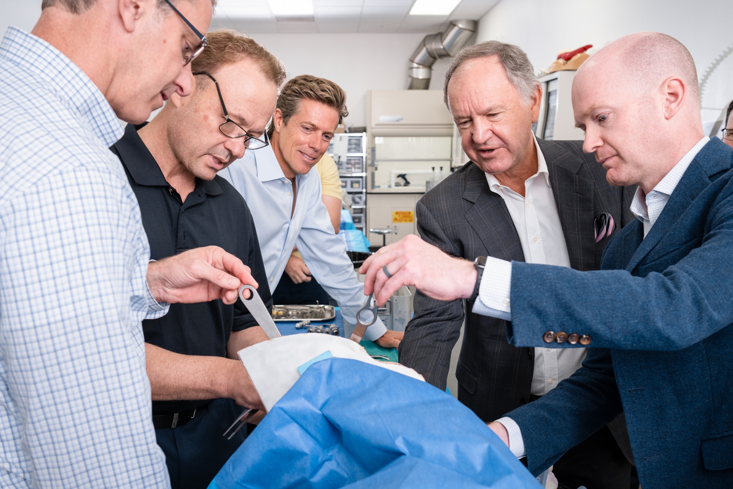 Reinhold Schmieding views the use of a medical tool