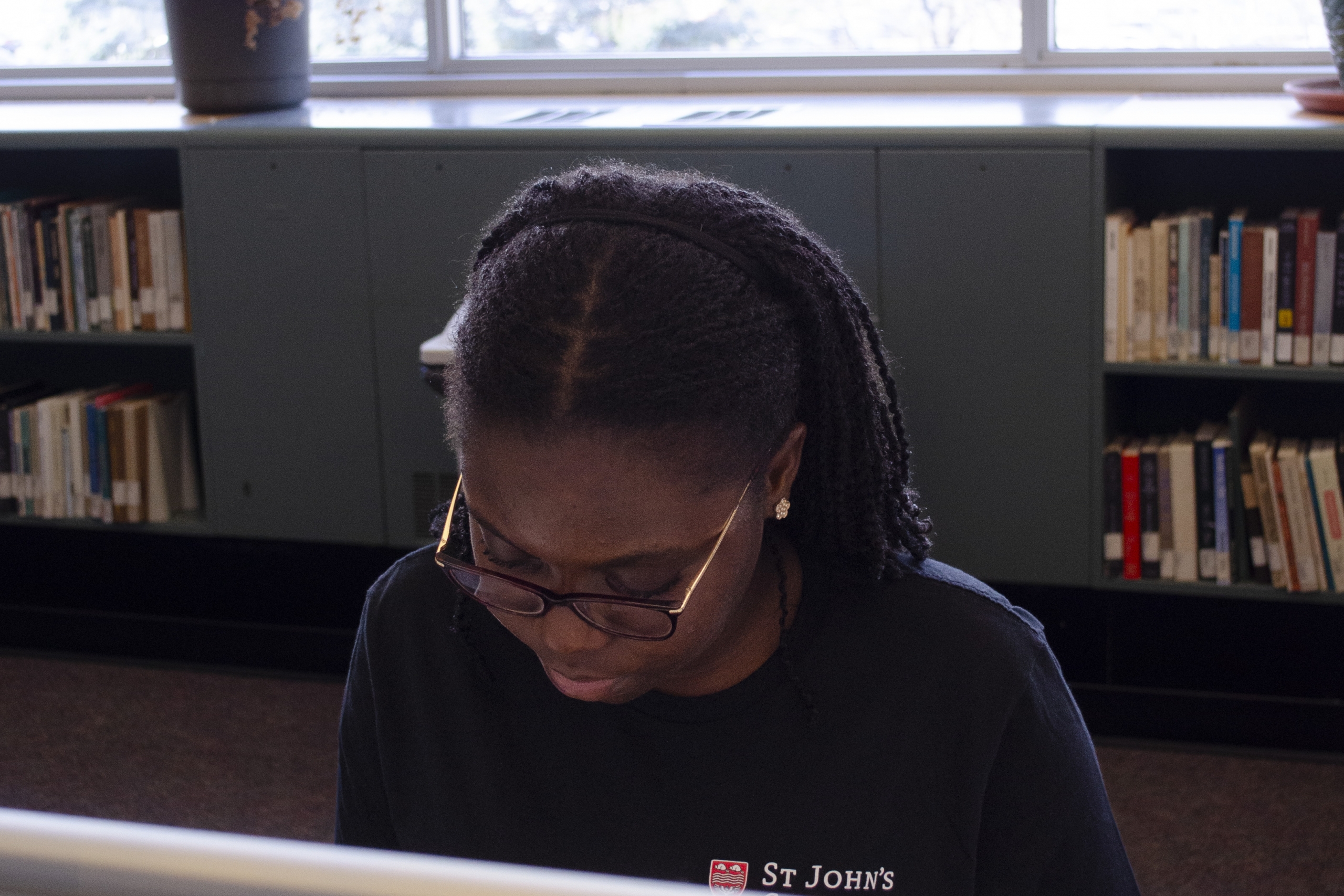 Treasure Johnson studying in a library with bright windows