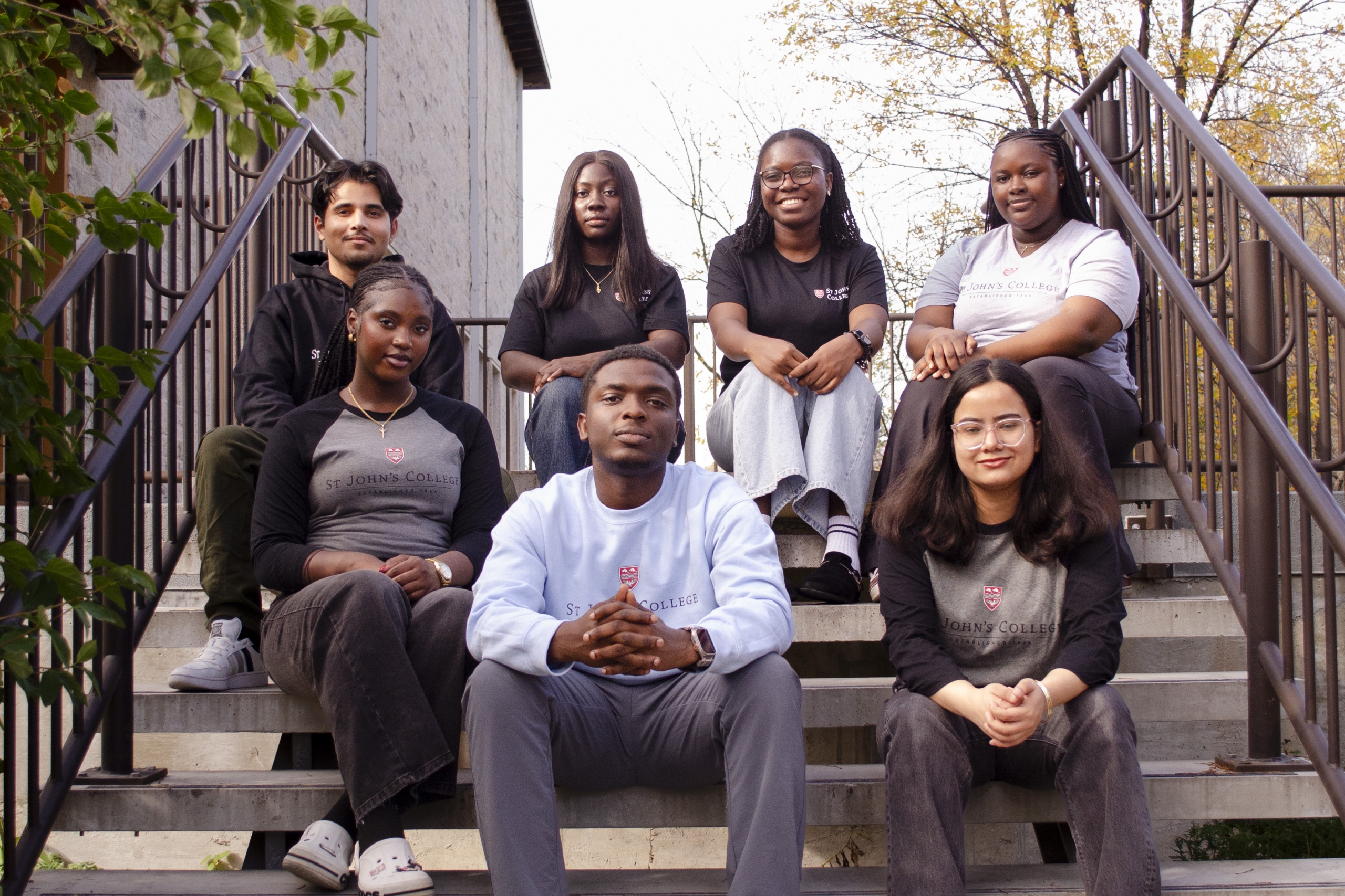 Students sitting on a set of stairs outdoors