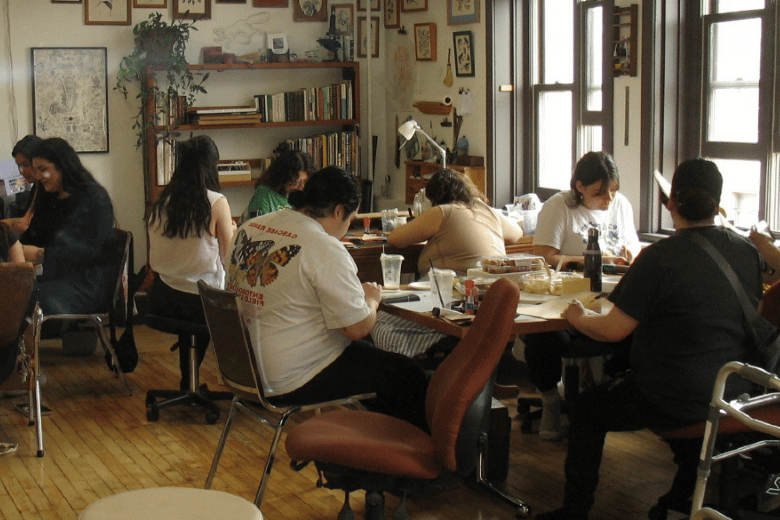 Participants gather around tables for a Two-Spirit arts and culture workshop.