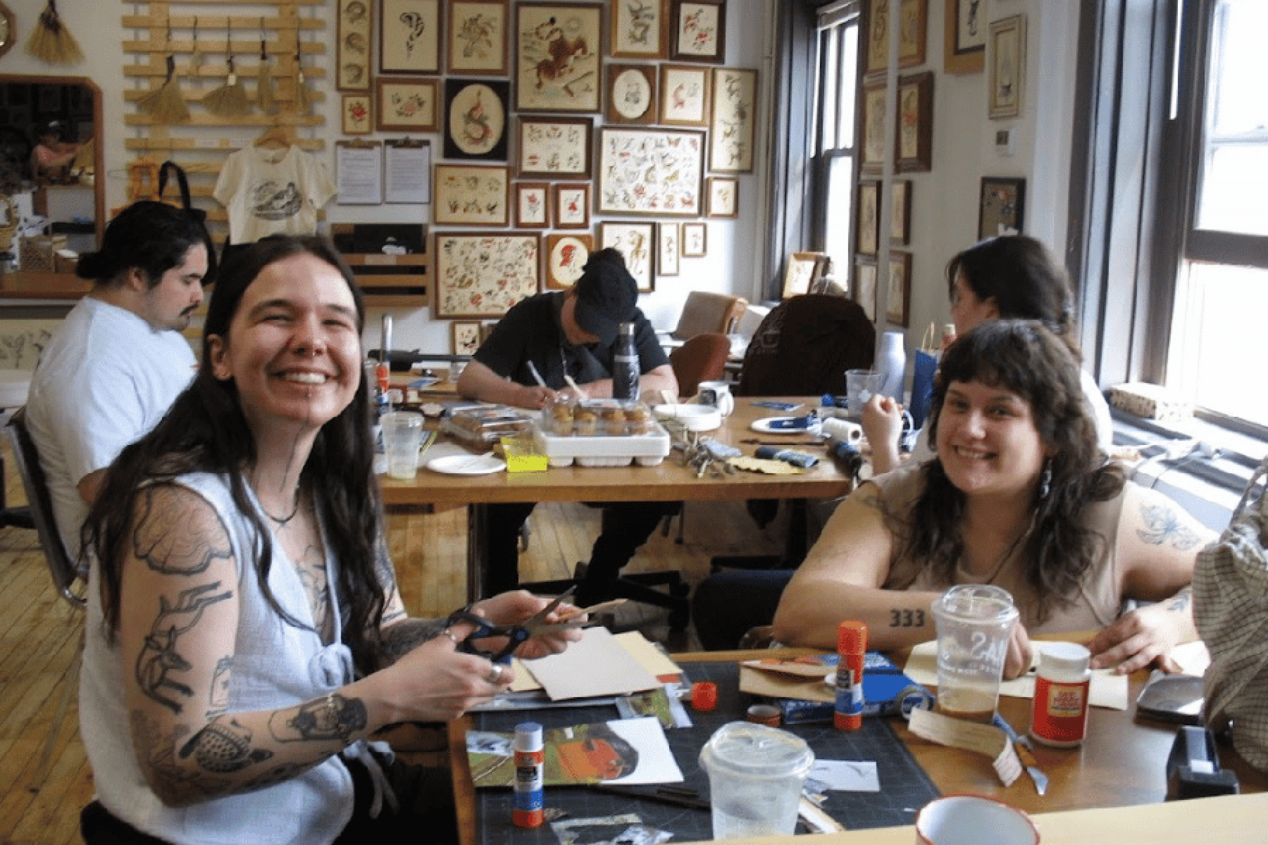 Participants smile while creating art together during a Two-Spirit workshop.