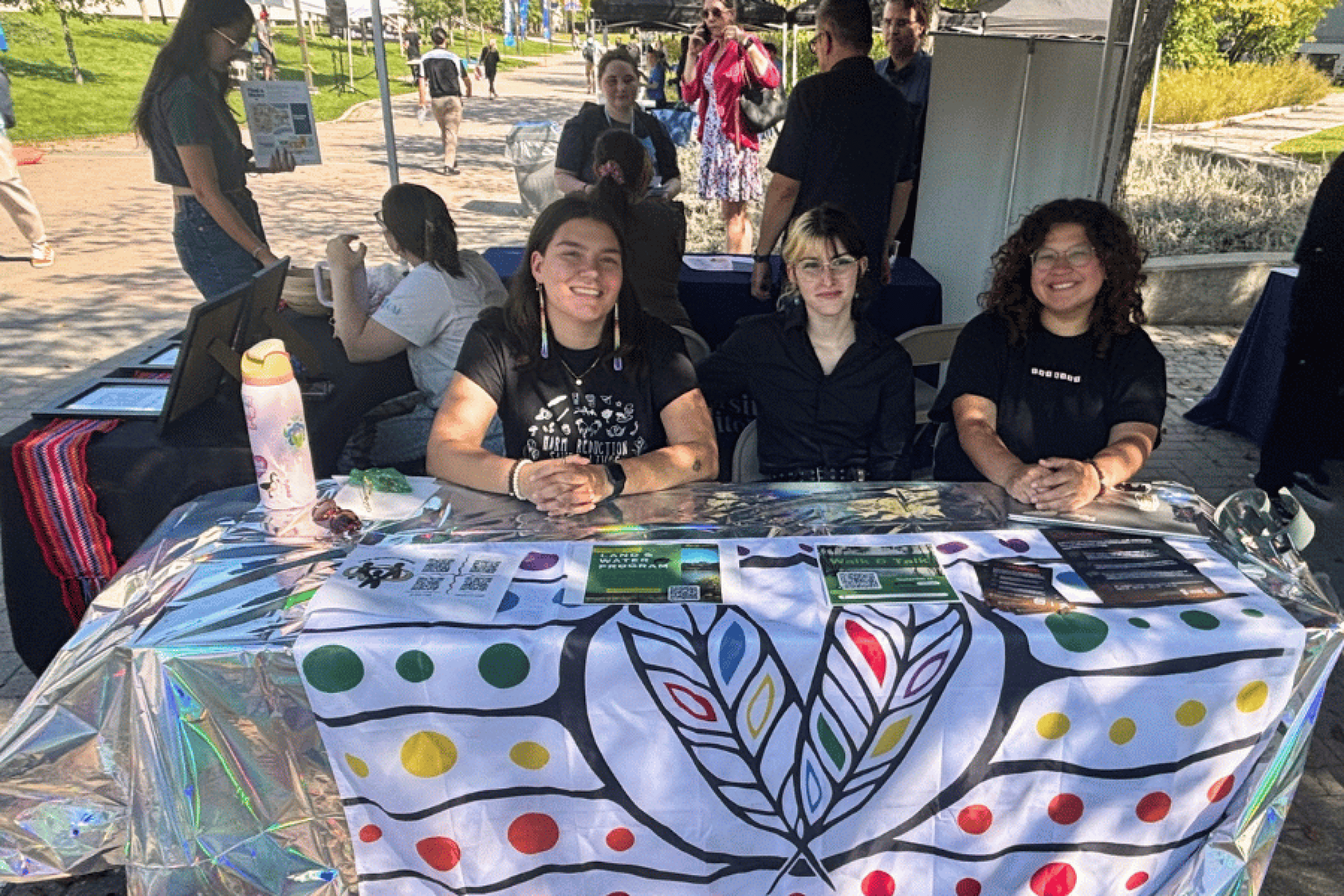 Two-Spirits Talking members host an information table at a campus event.