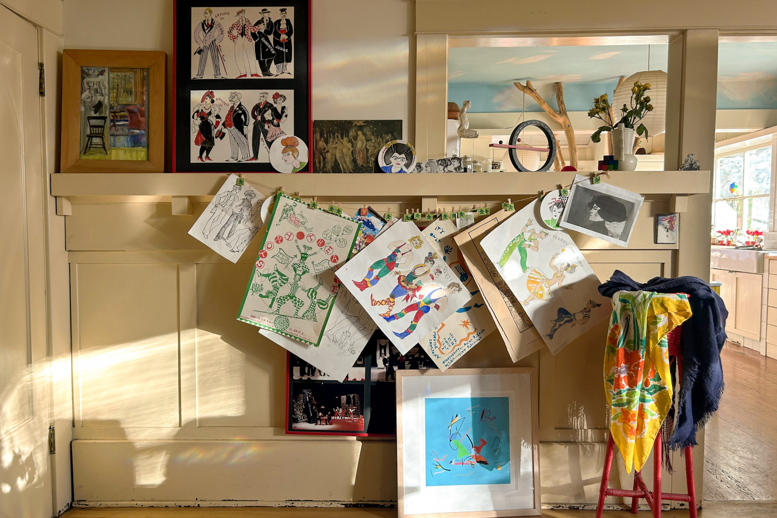 The wall of a home with drawings hung