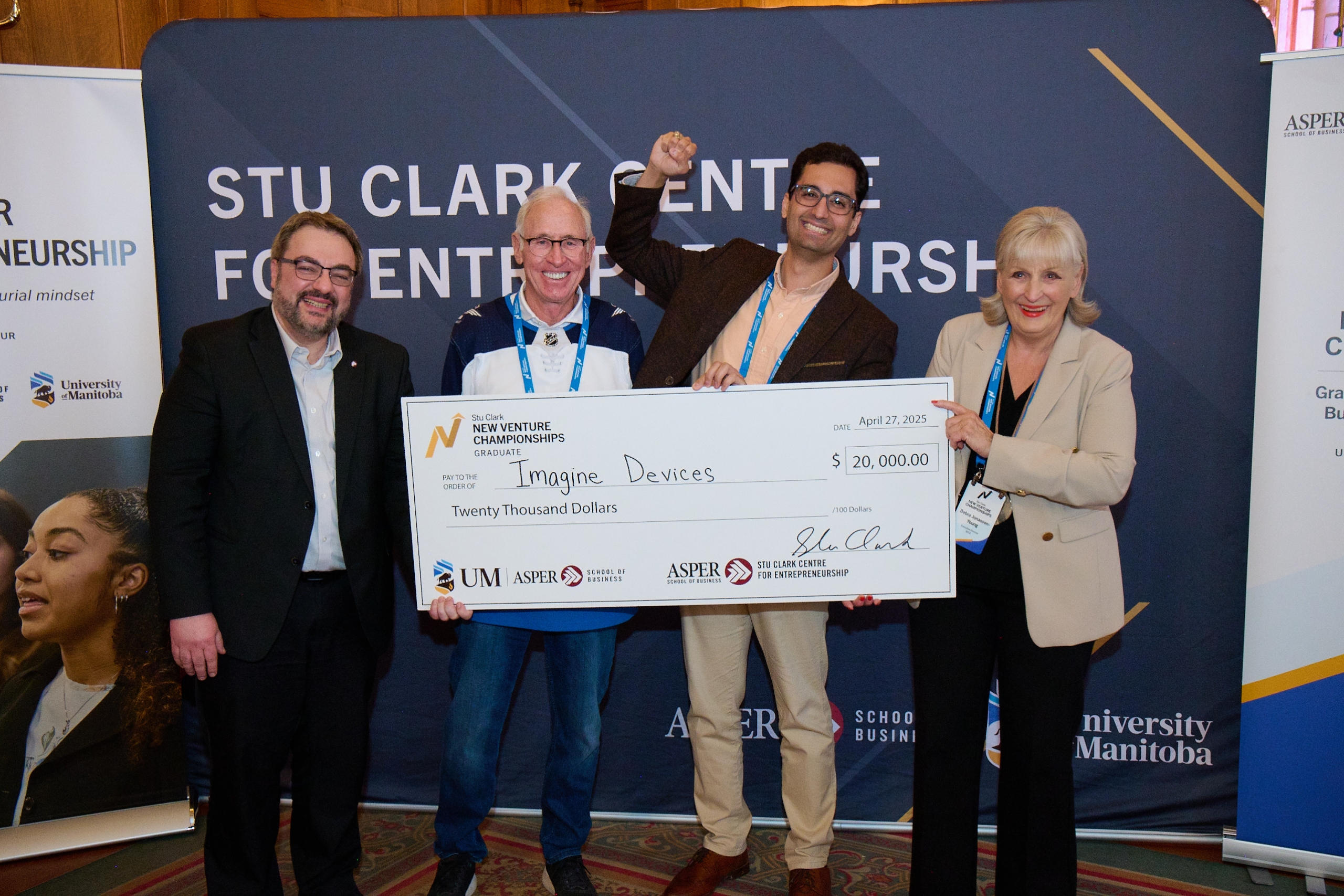 4 individuals hold a large cheque