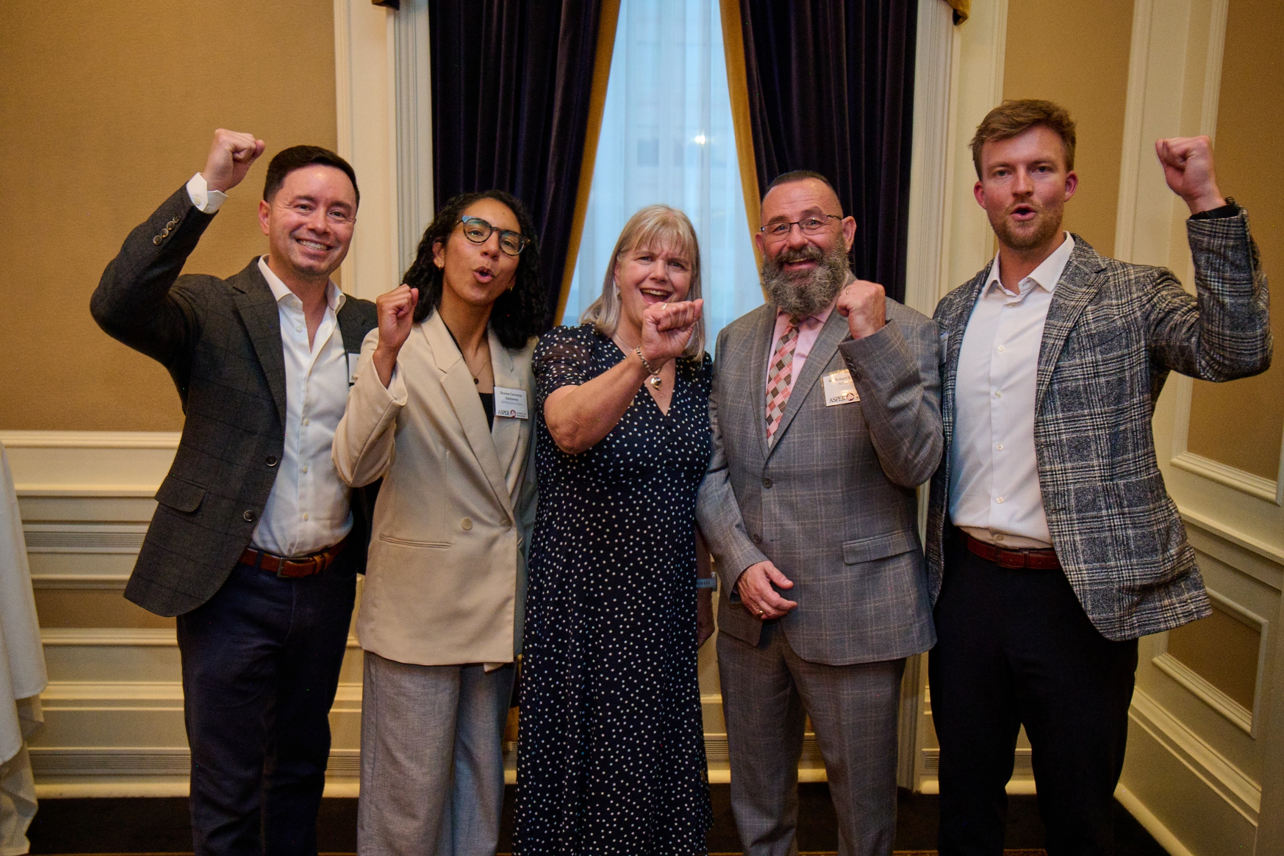 A panel of speakers poses for a photo