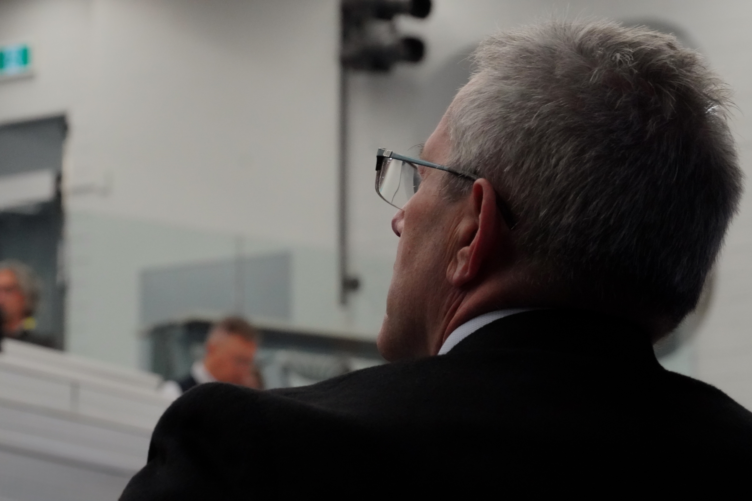 a person standing and looking at the audience