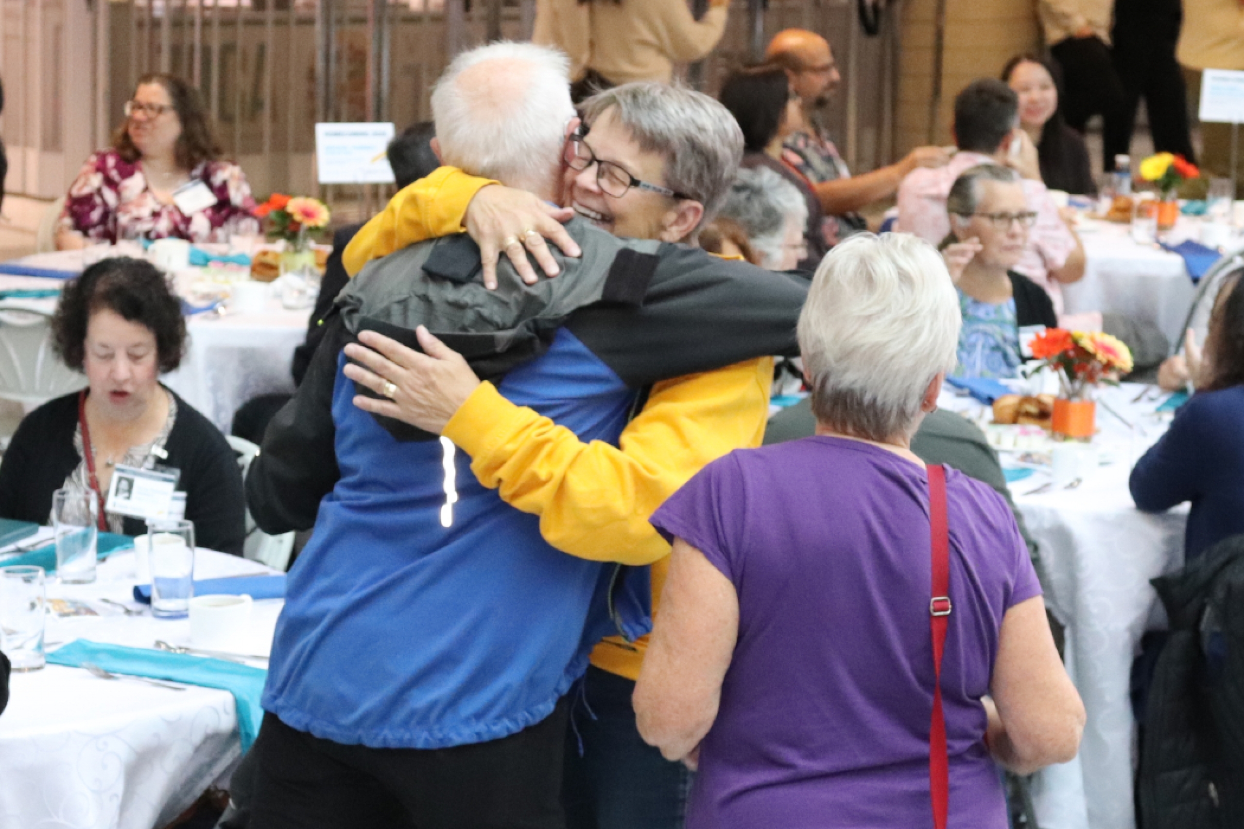 Two people hug. 