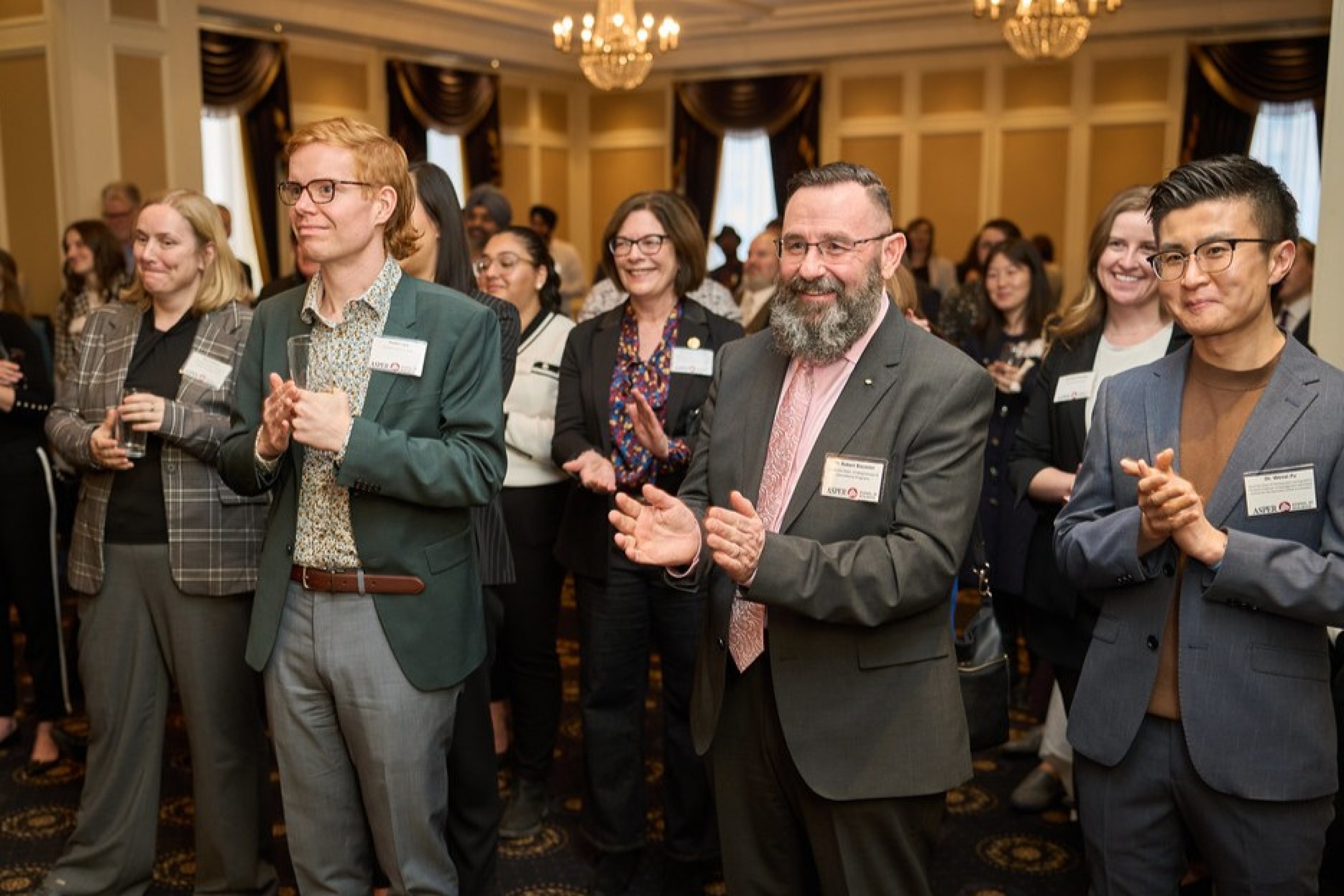 Dr. Robert Biscontri claps at an event