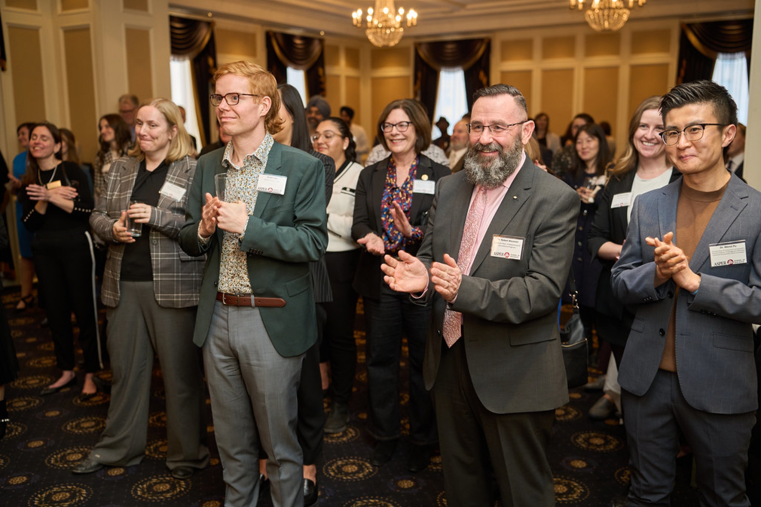 Dr. Robert Biscontri claps at an event