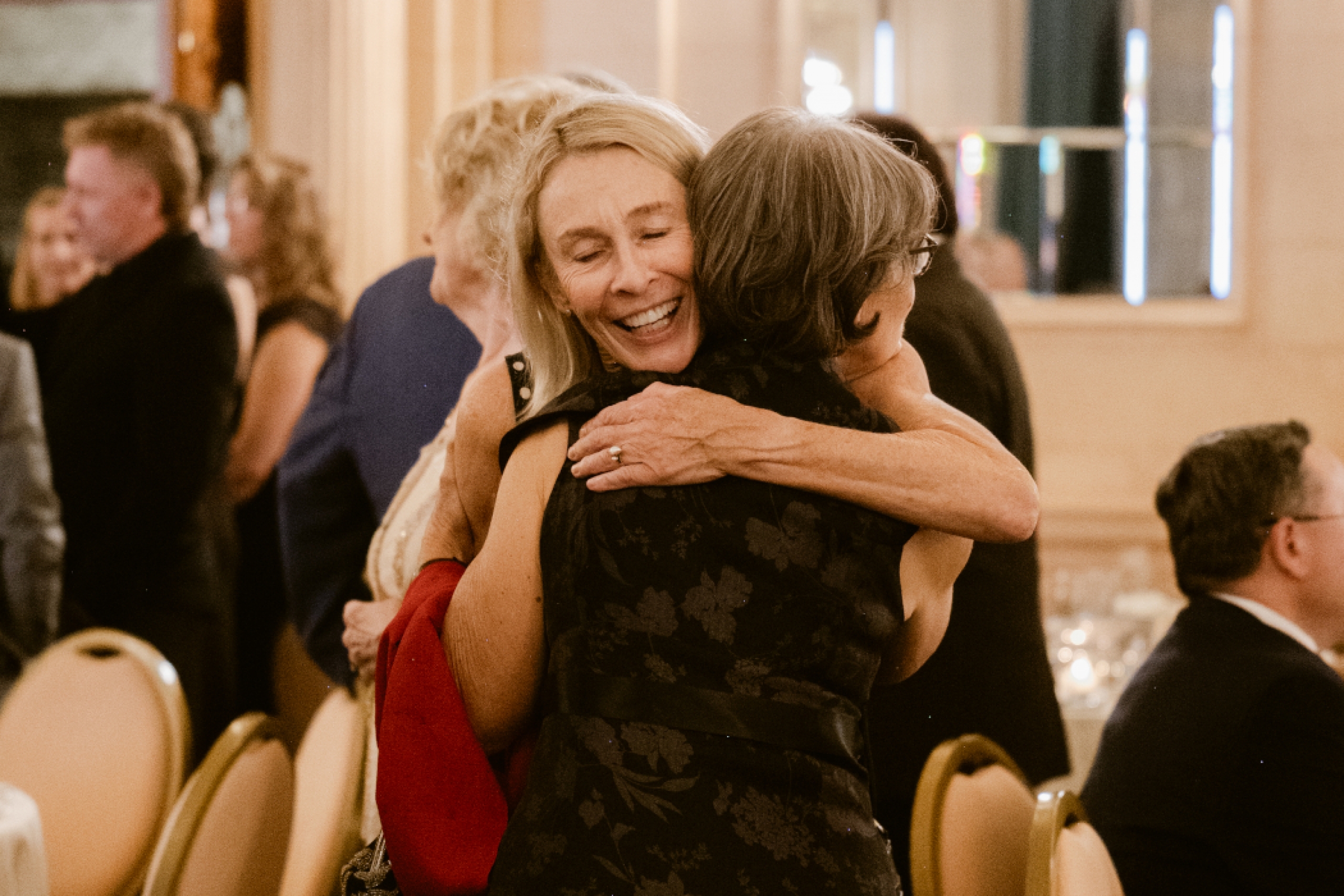 Two people hug. 