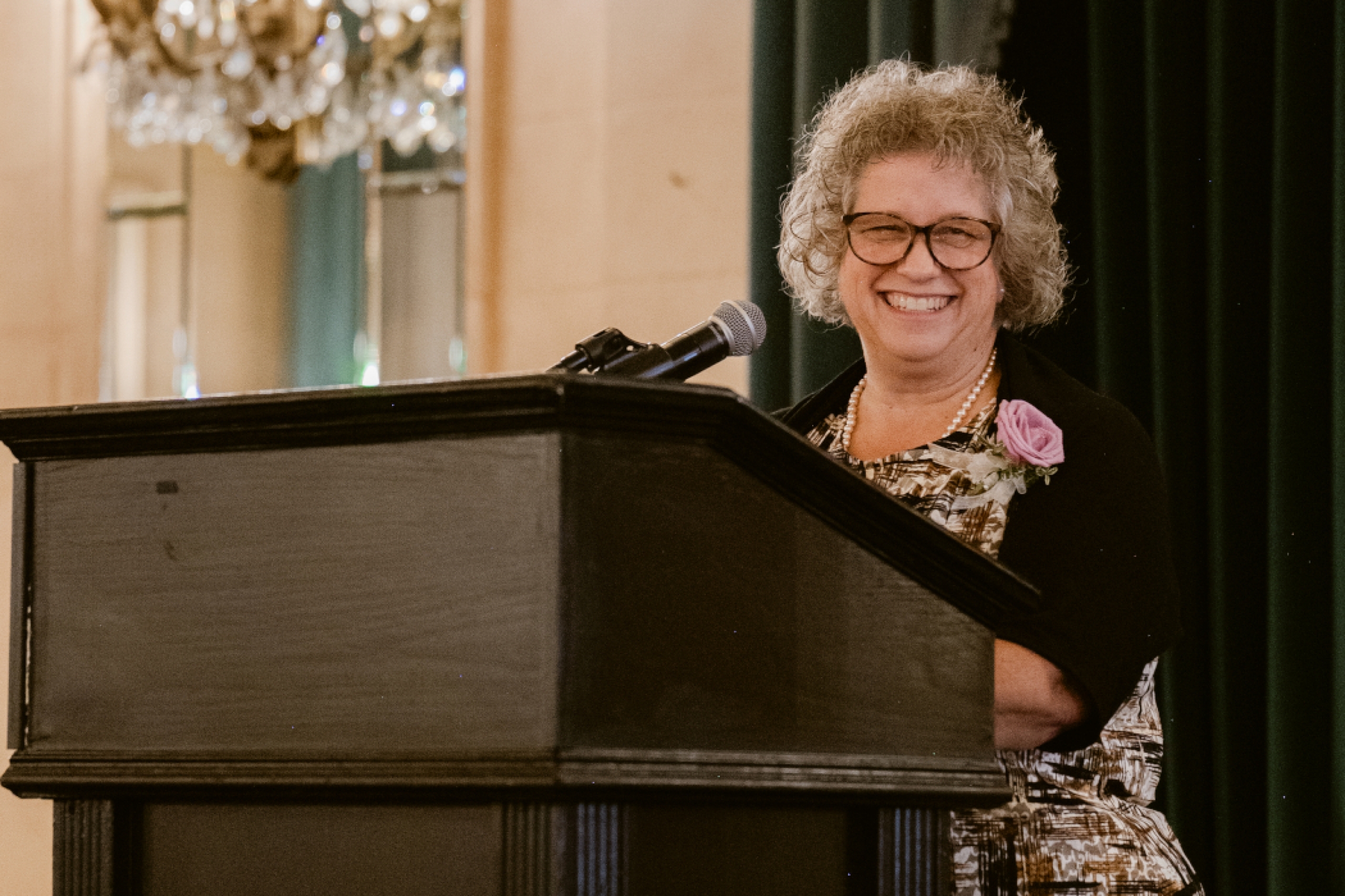 Linda Pharand speaks at a lectern. 