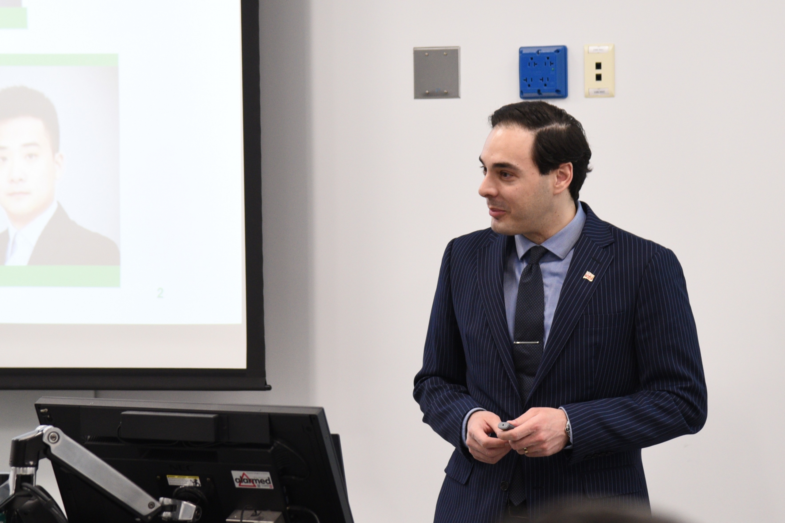 Paris Fragkoulis presents at a podium