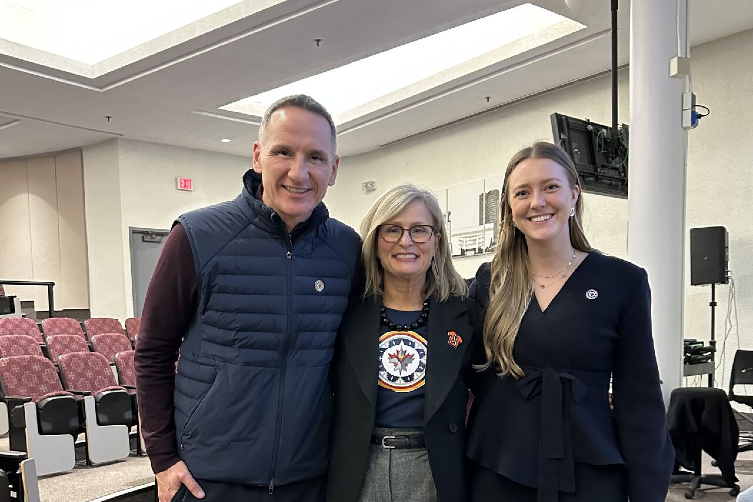 Three individuals pose together for a photo