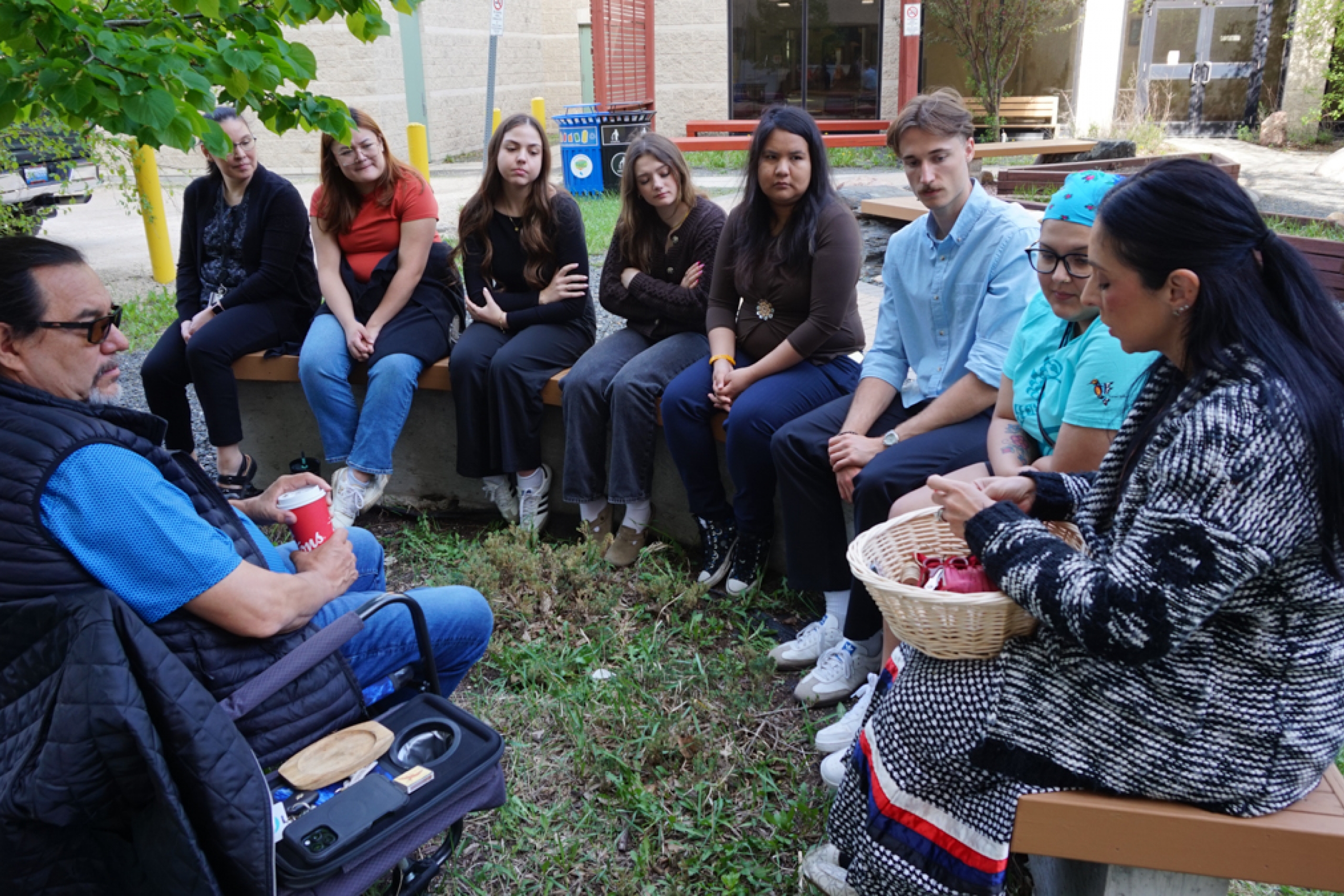 A group of people in a circle outdoors.