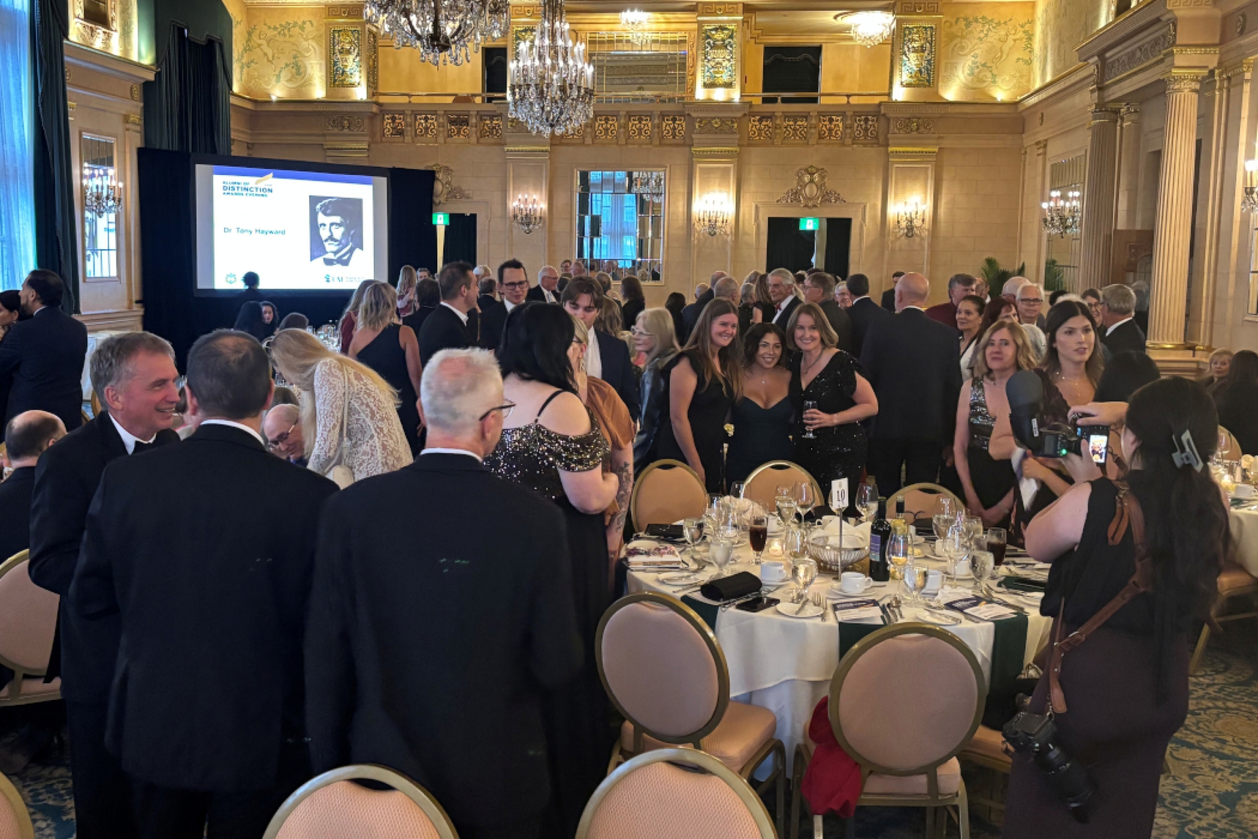 A crowd in a ballroom prior to an event. 