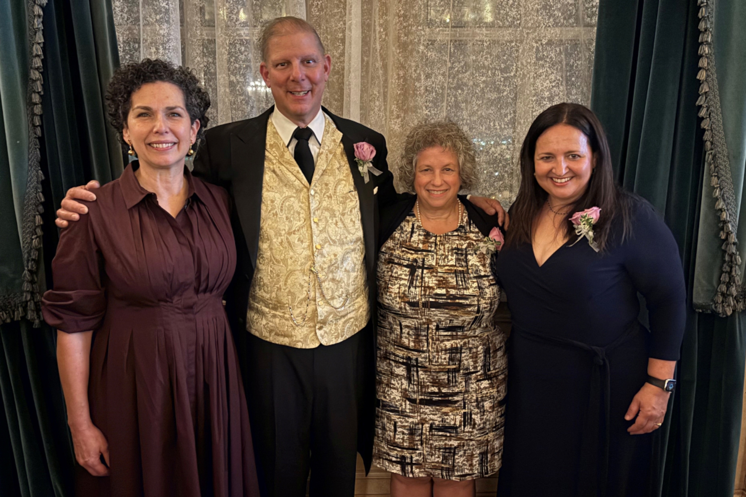 Four people pose for a photo. 