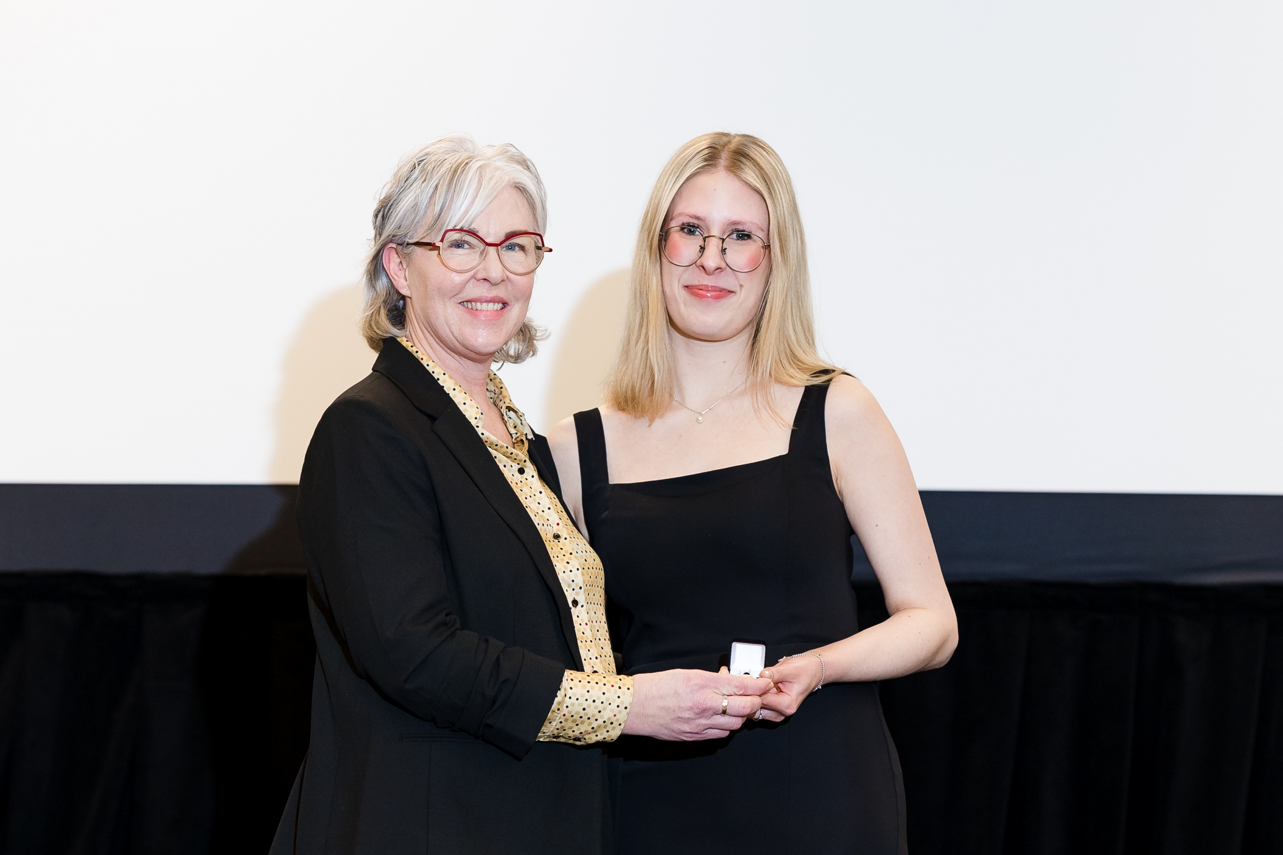 Svava Olsen receives her nursing pin from Dr. Kellie Thiessen.