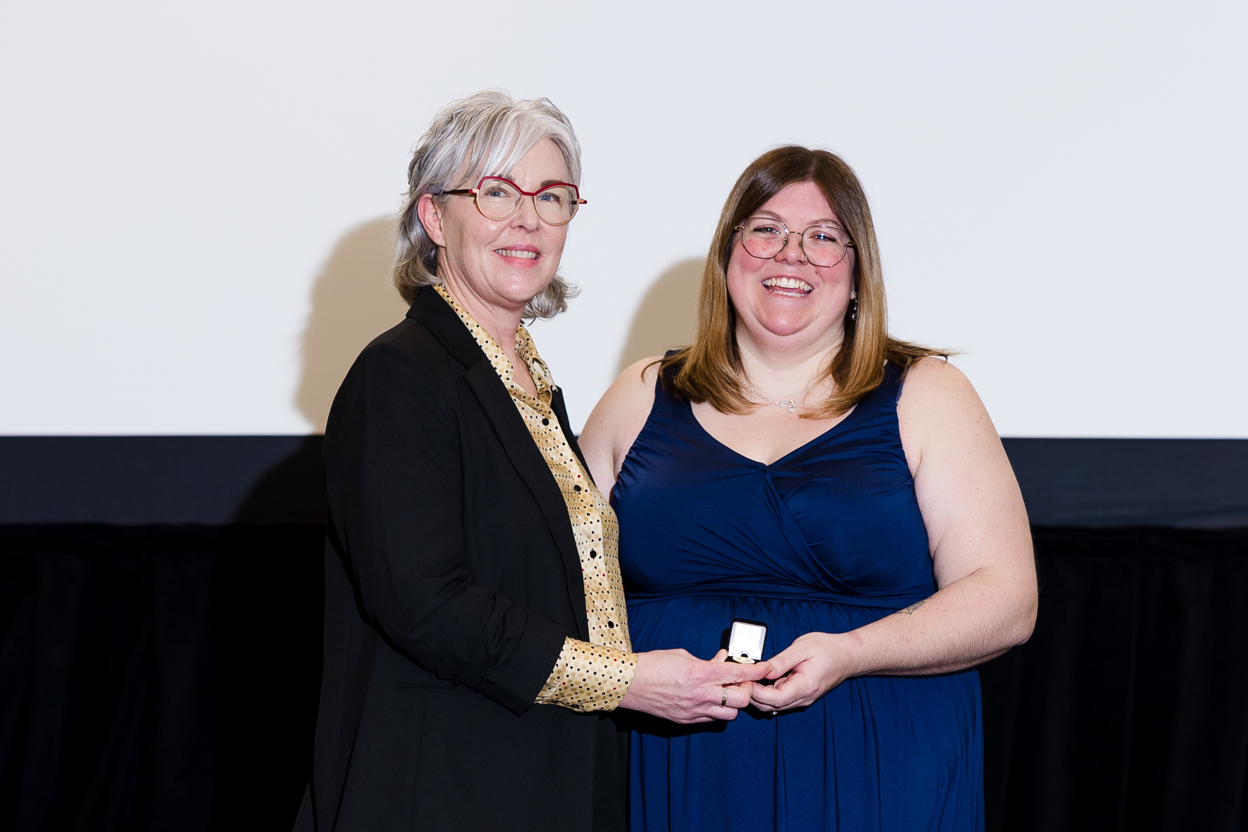 Kristen Stephens receives her nursing pin from Dr. Kellie Thiessen.