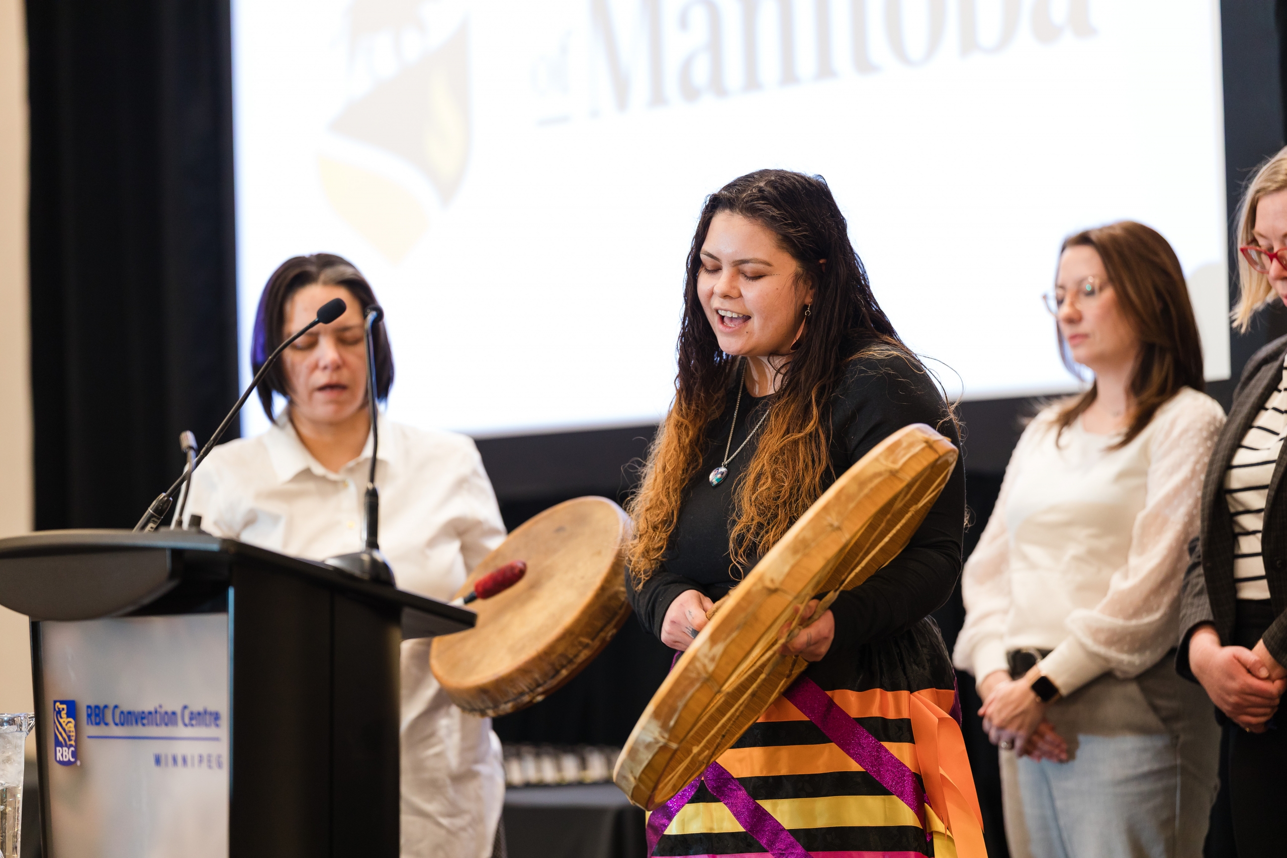 Deidre and Natasha Acoby perform an honour song.