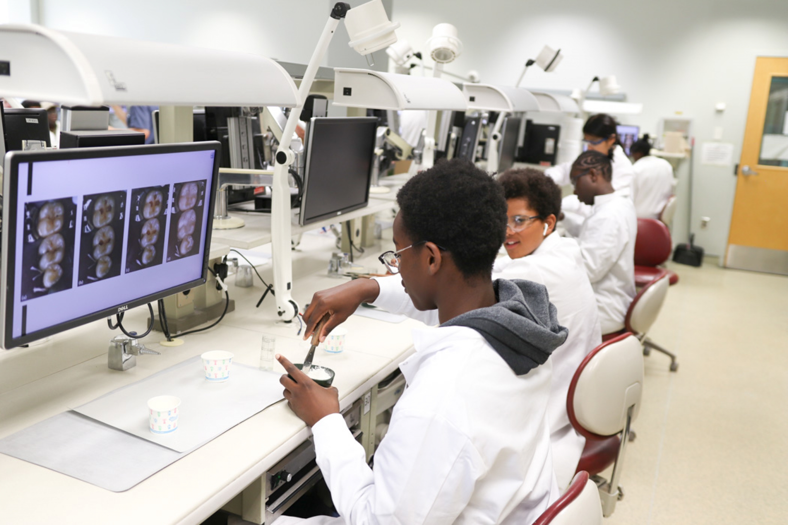 Campers seated in the dentistry lab, engaged in a hands-on activity.