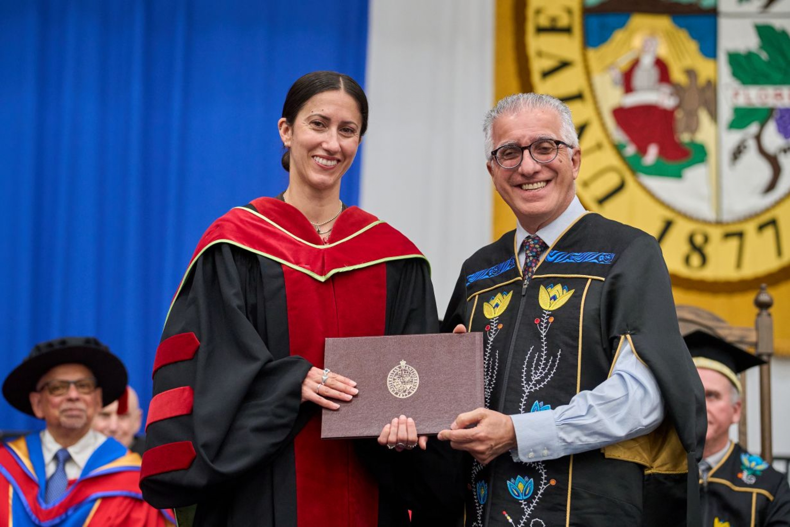 Barr receives award from President Benarroch at convocation ceremony.