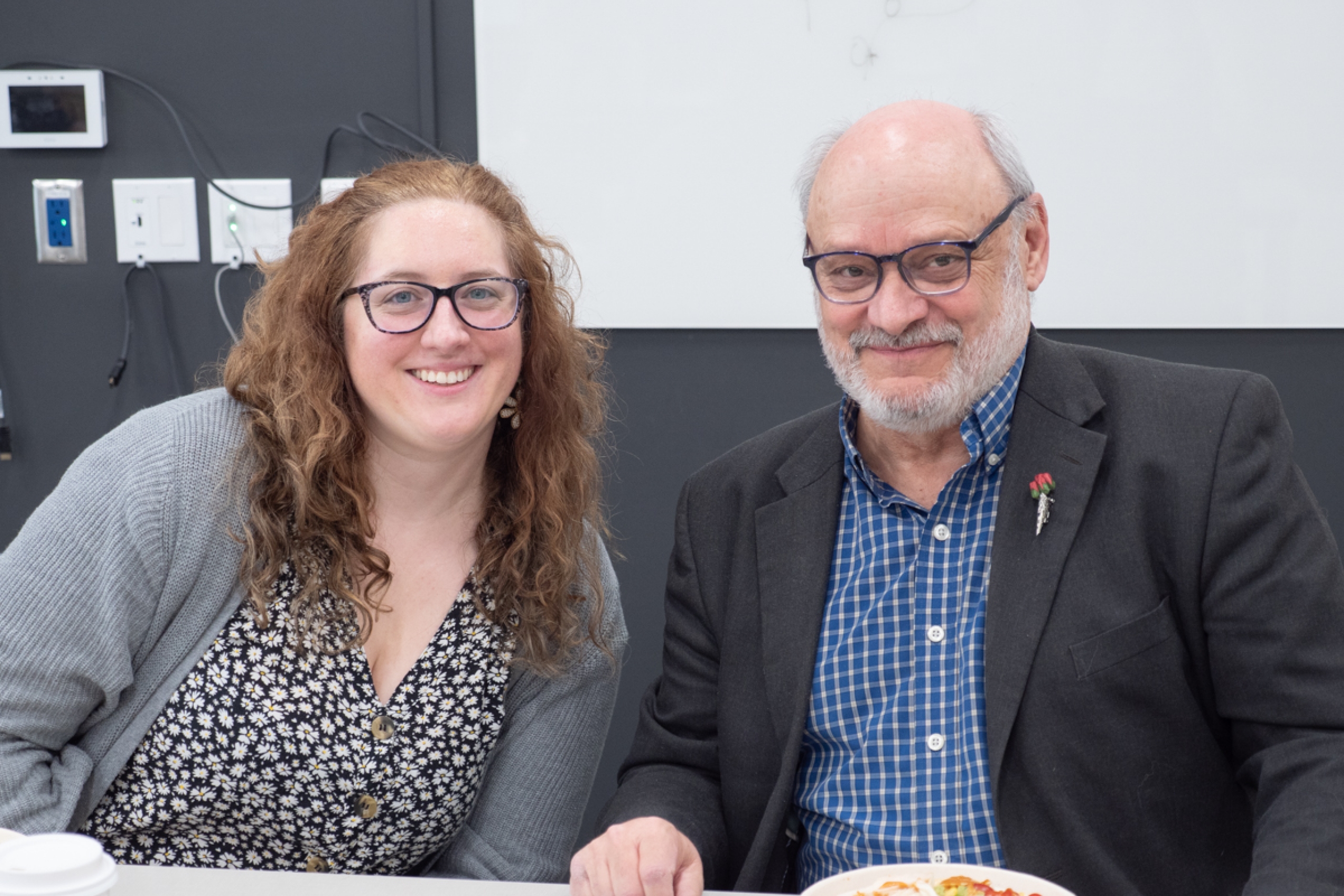 Two people smile for the camera.