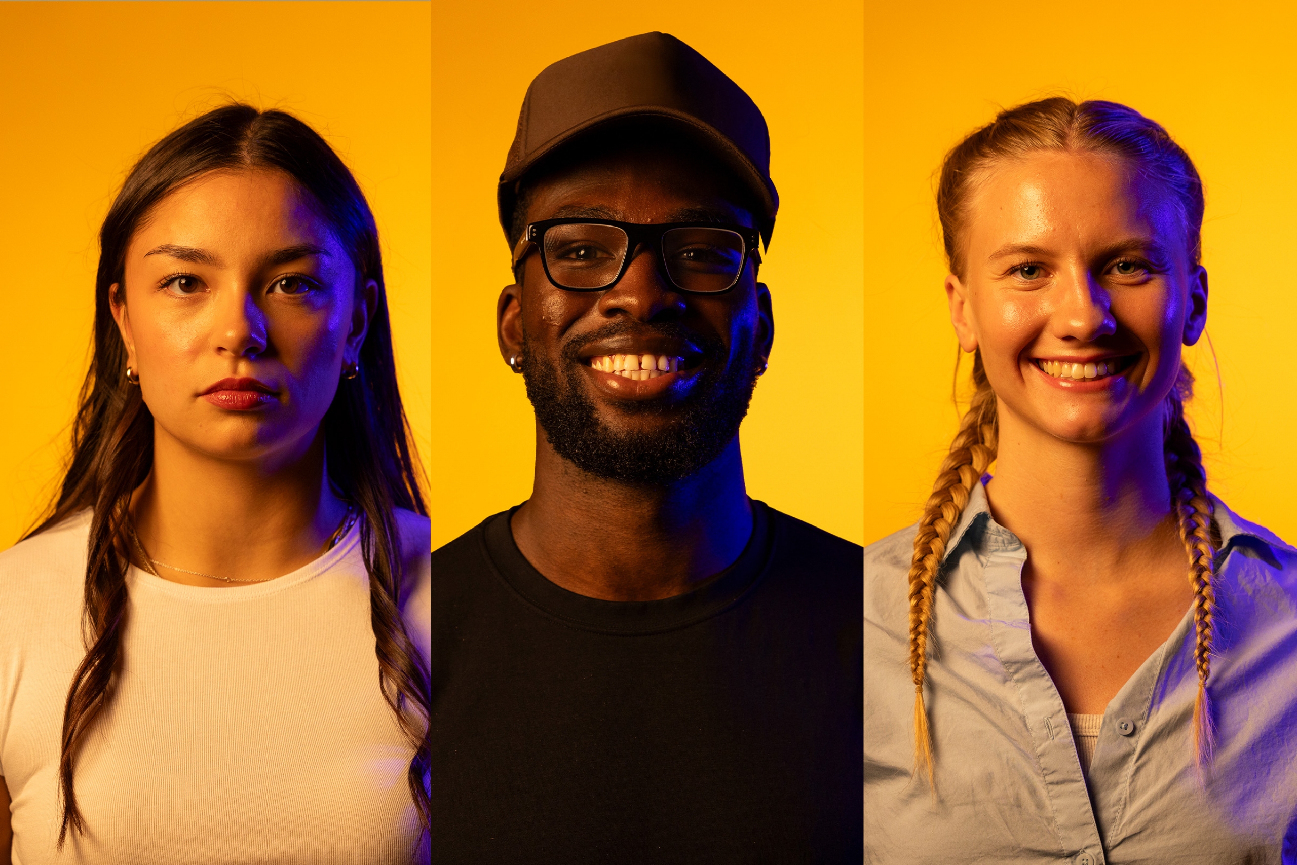 Three student-athletes standing against a gold back drop with blue light mimicing the new Bisons logo