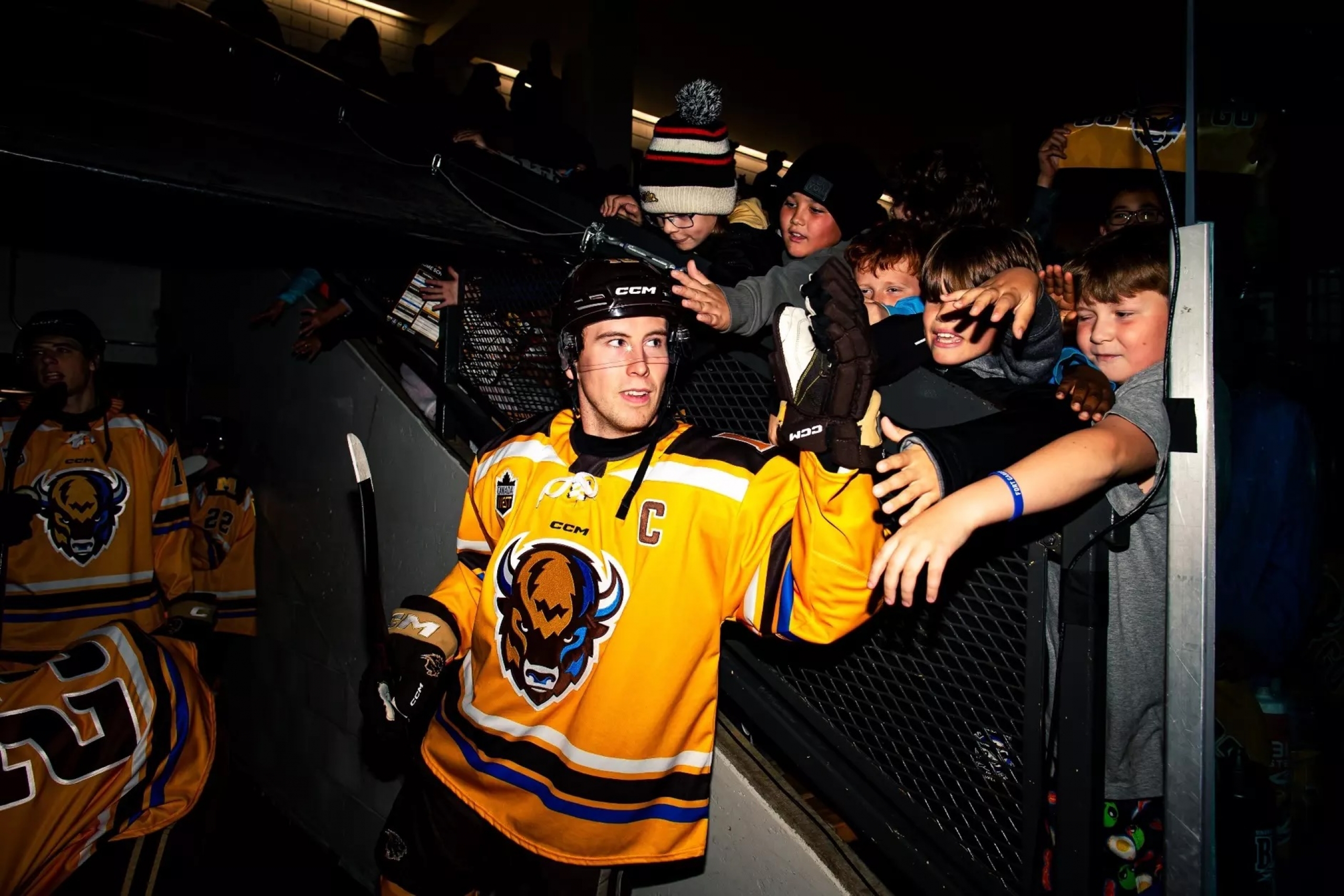 Bisons hockey player Jonny Hooker greeting fans after a game