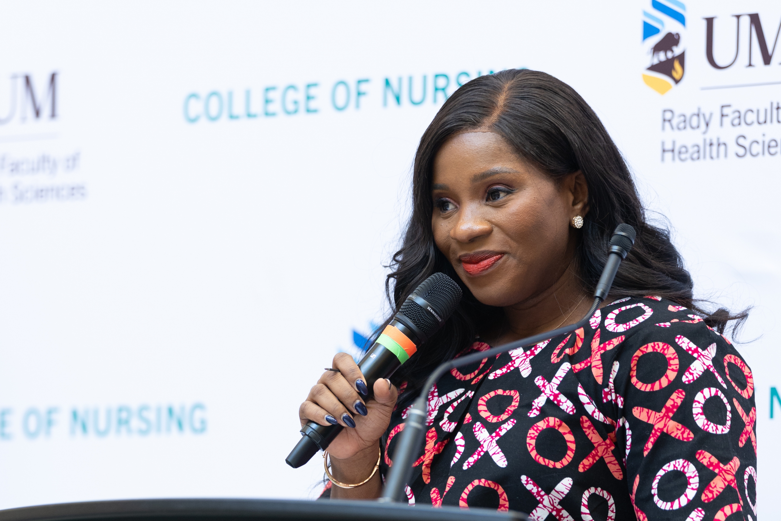 Nurse practitioner and CEO of Mara Home and Health Services Ann Nzeruem at a podium.