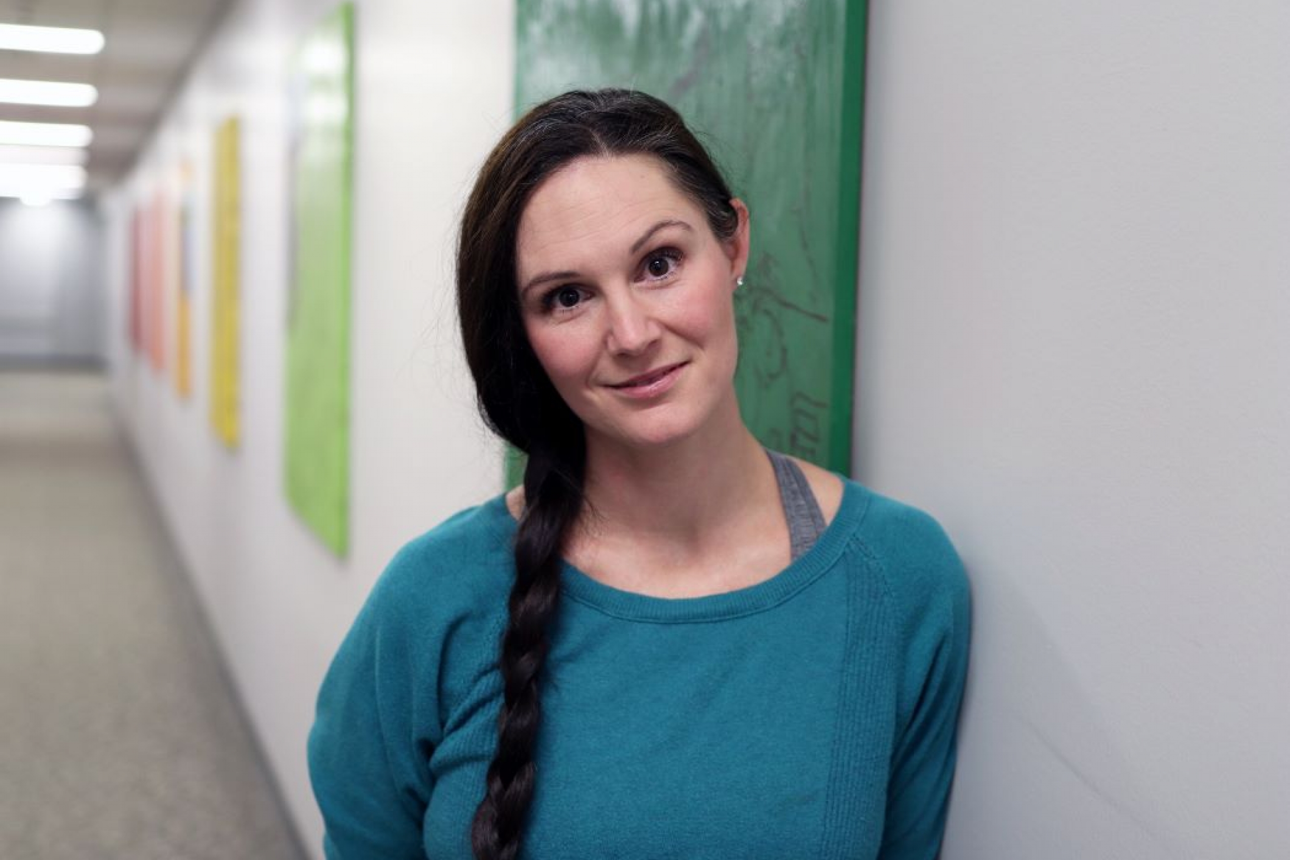 Dr. Laura Bowler stands in a hallway at the University of Manitoba.