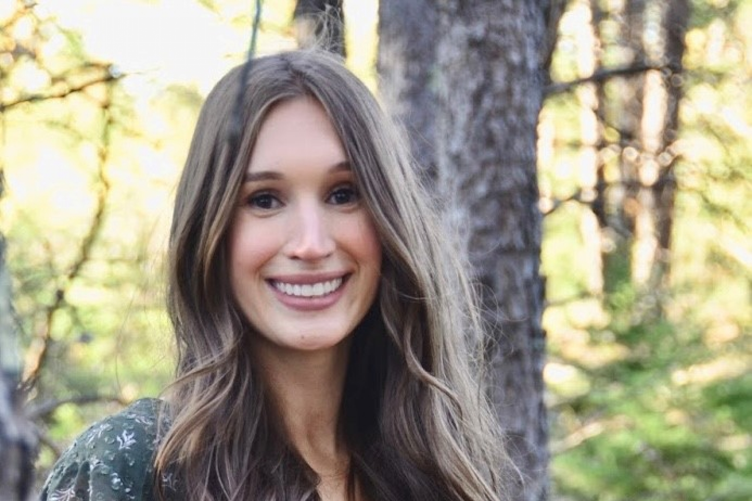 Bree Cruise stands in a forest.