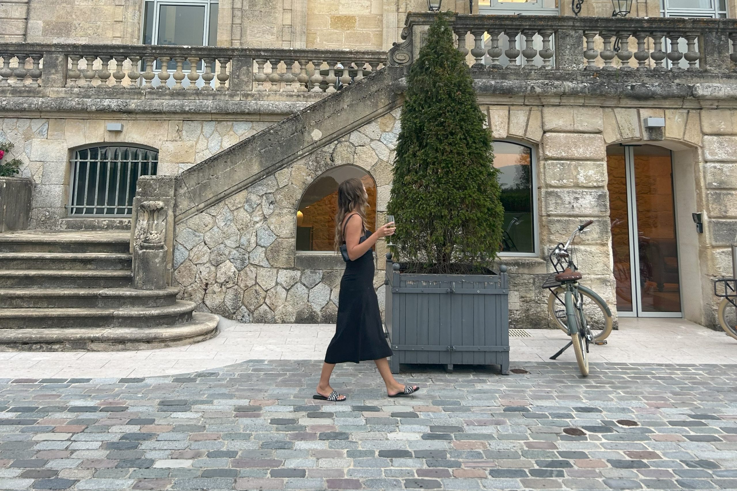 Brooke walks in front of a stone building in Europe
